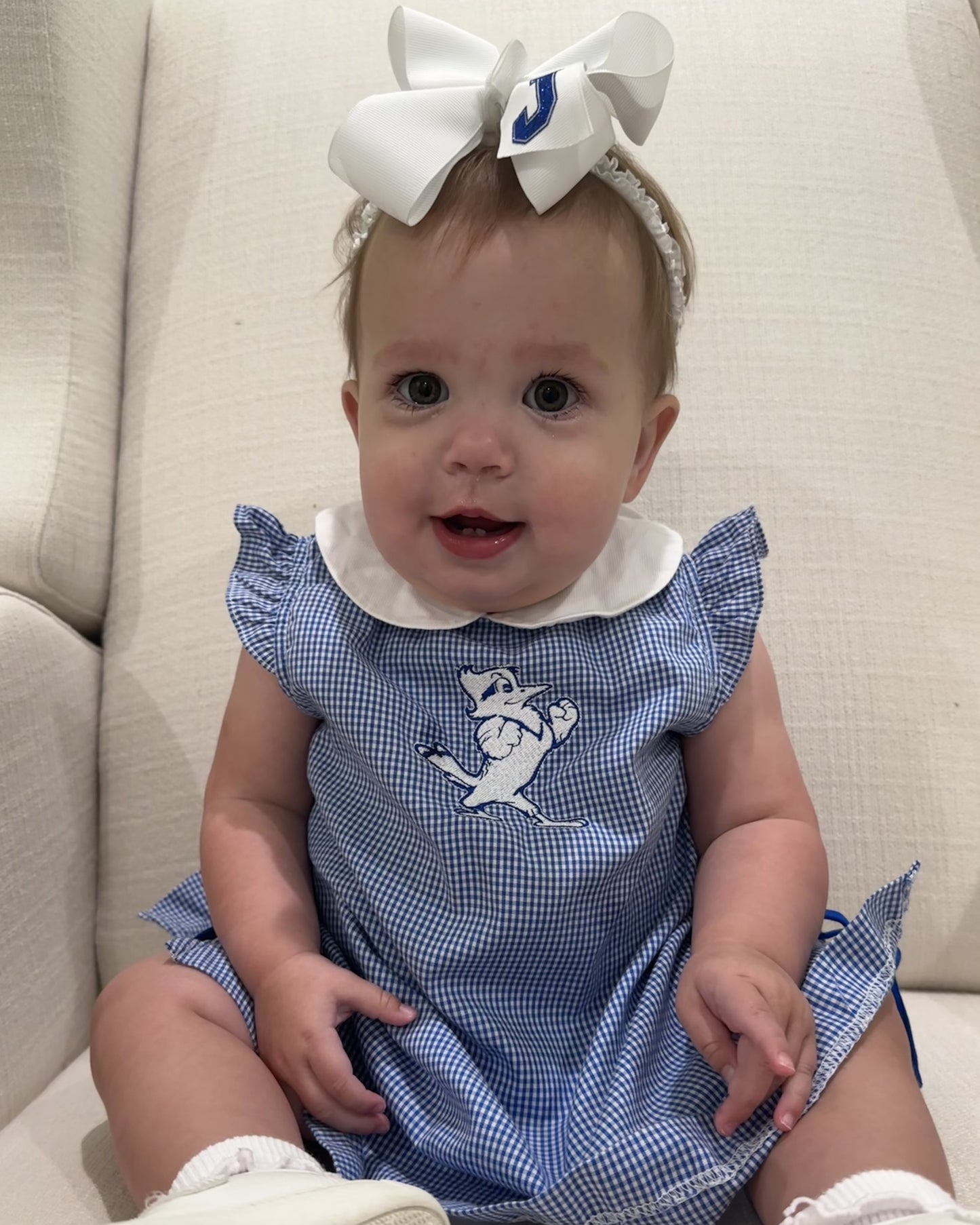 Hi! My name is Amelia and my dad is an '07 graduate. I'm wearing a size 18 month in the Ella Dress!