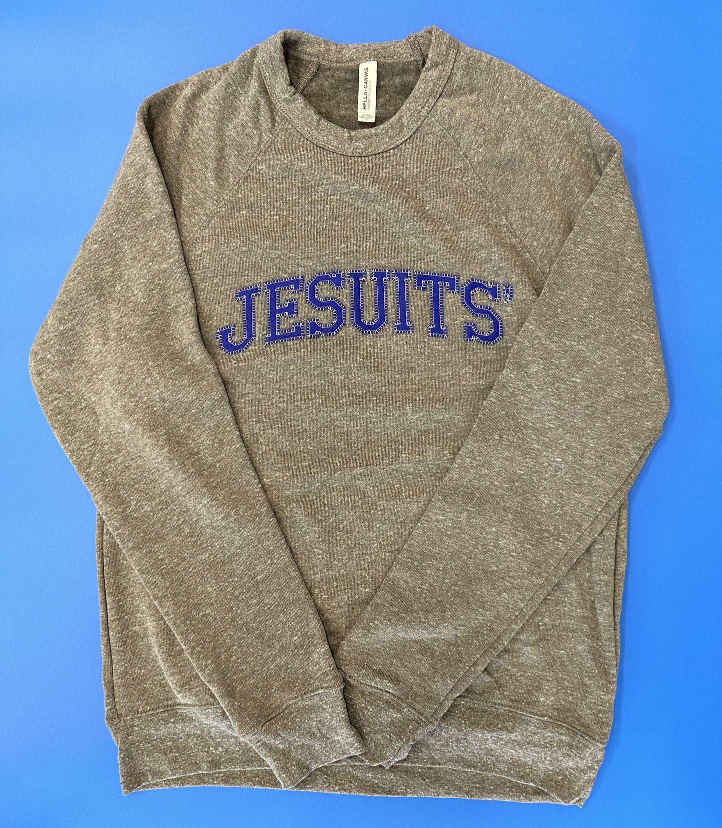 Bella + Canvas. 50% Polyester Fleece, 37.5% Airlume combed & ring-spun cotton, 12.5% rayon. Spun from plush sponge fleece fabric. Remarkably soft pullover crewneck sweatshirt. Featuring ribbed cuffs & waistband. Raglan sleeves.