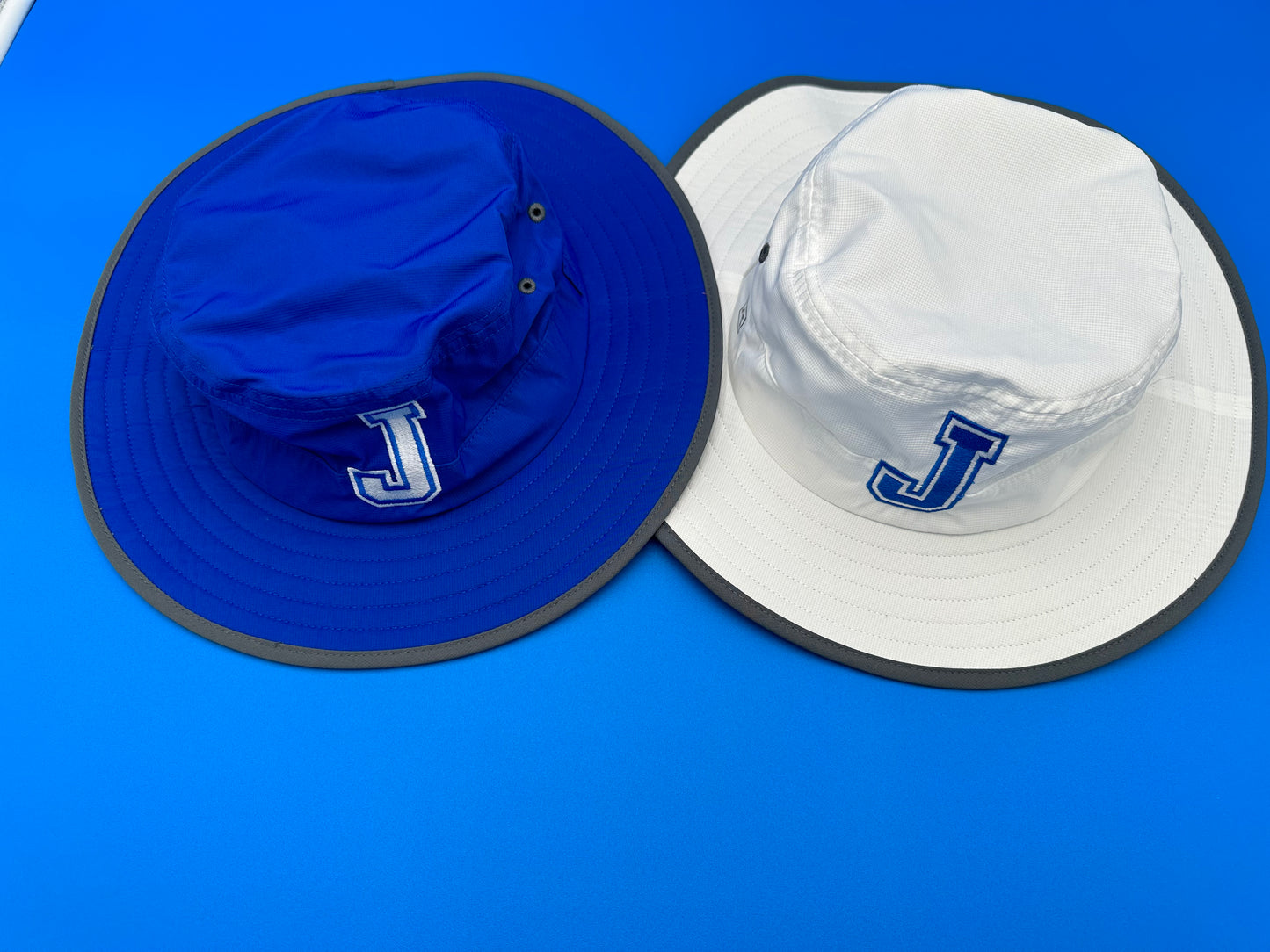 Richardson. 100% Polyester. Lightweight Performance Fabric. One Size Fits Most (w/adjustable elastic band). Available with J or Jayson logo in Royal Blue or White!
