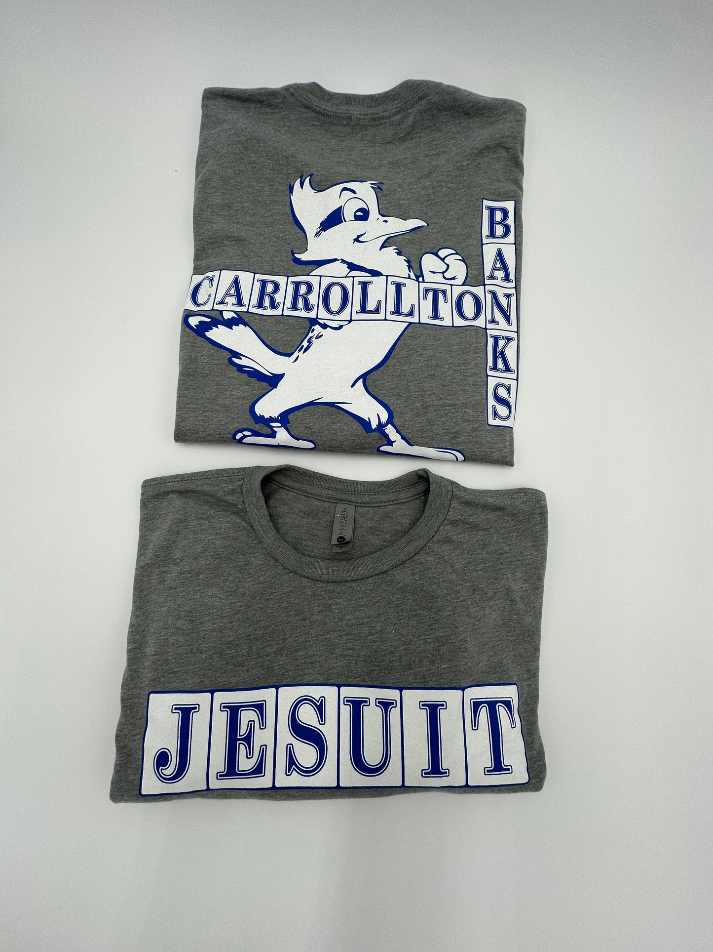Next Level. 60% Cotton/40% Polyester. Exclusive Jesuit NOLA Street Tiles Tee.