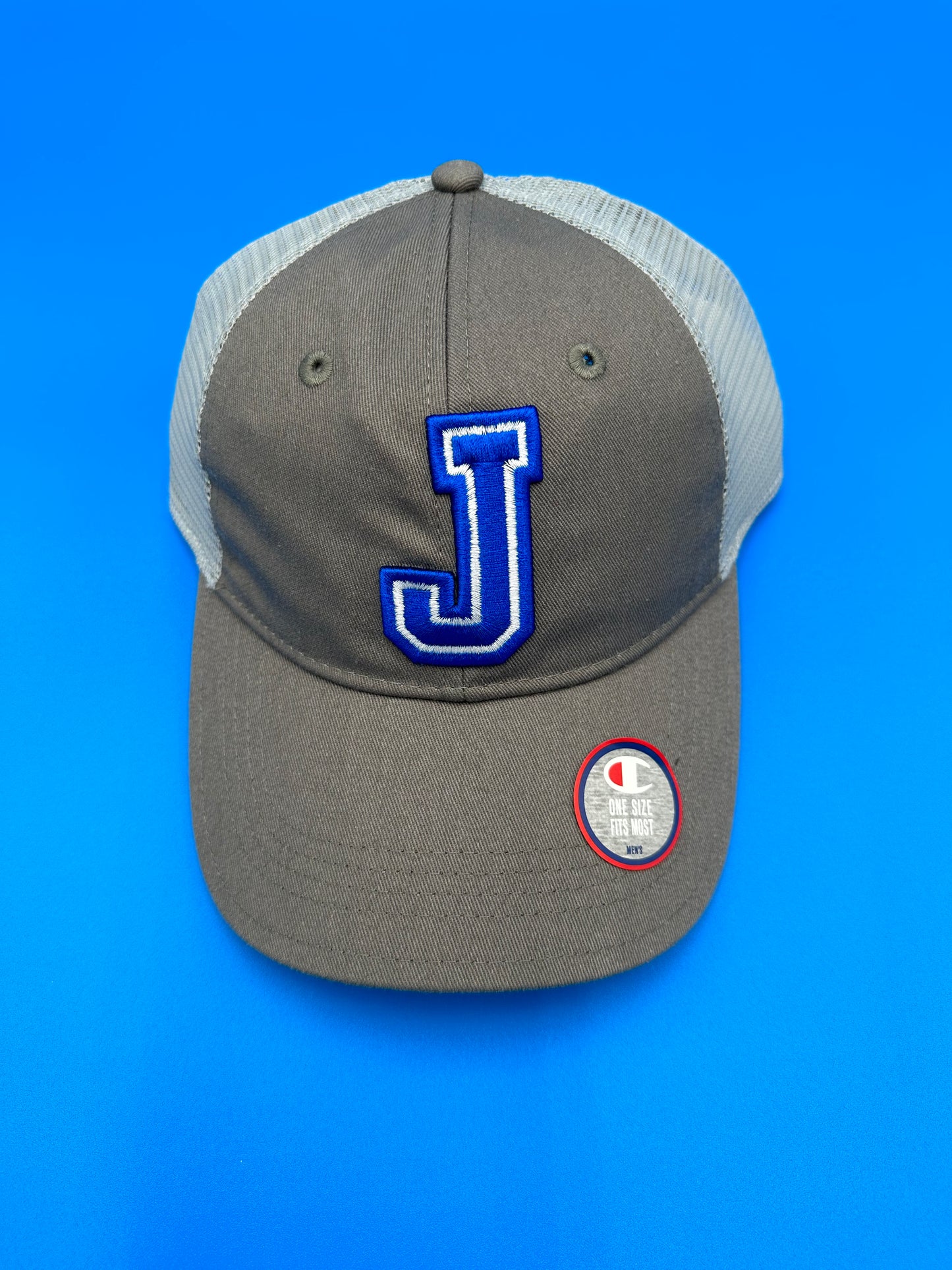 Champion. 65% Polyester/35% Cotton twill front/100% Polyester mesh back panels. Unstructured, low profile fit. Plastic snap closure. Cool Grey w/Light Grey Mesh. With 3D J Embroidery.