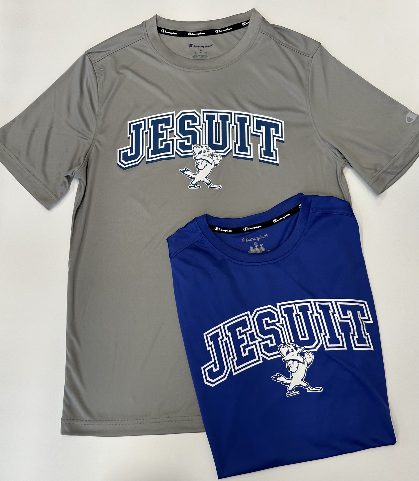 Champion. From the 2024 Stadium Collection. 100% Polyester. Self Collar. Set in sleeve construction. Screen-printed Jesuit logos.