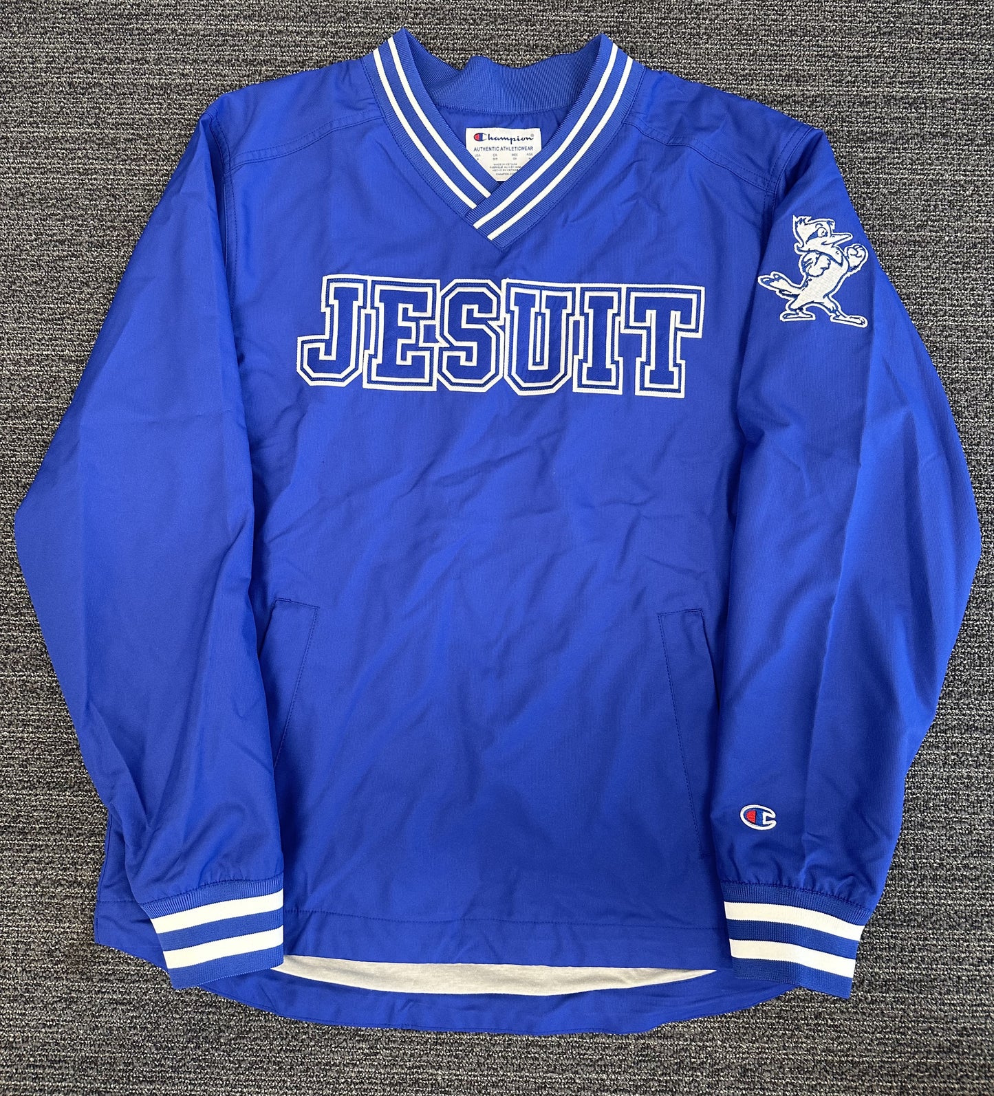Champion Outer: 100% Polyester. Jersey Knit Lining: 65% Polyester/35% Cotton. Adjustable at the waist. Water Resistant. Does run roomy so you may want to size down.