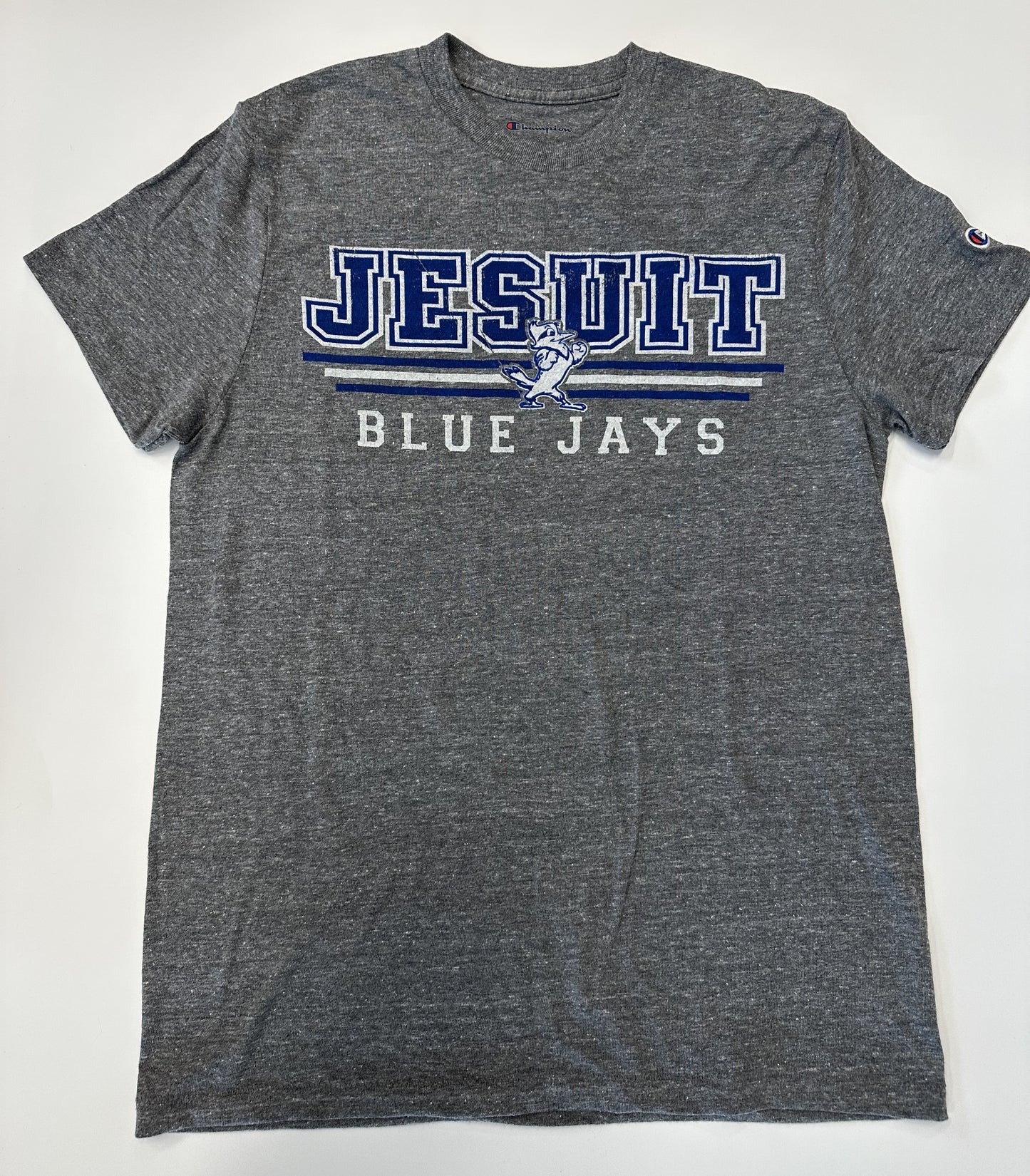 Champion. 50% Polyester/37% Cotton/13% Rayon Jersey. 1 x 1 rib at collar. Set in short sleeve with slightly shorter, more modern fit.