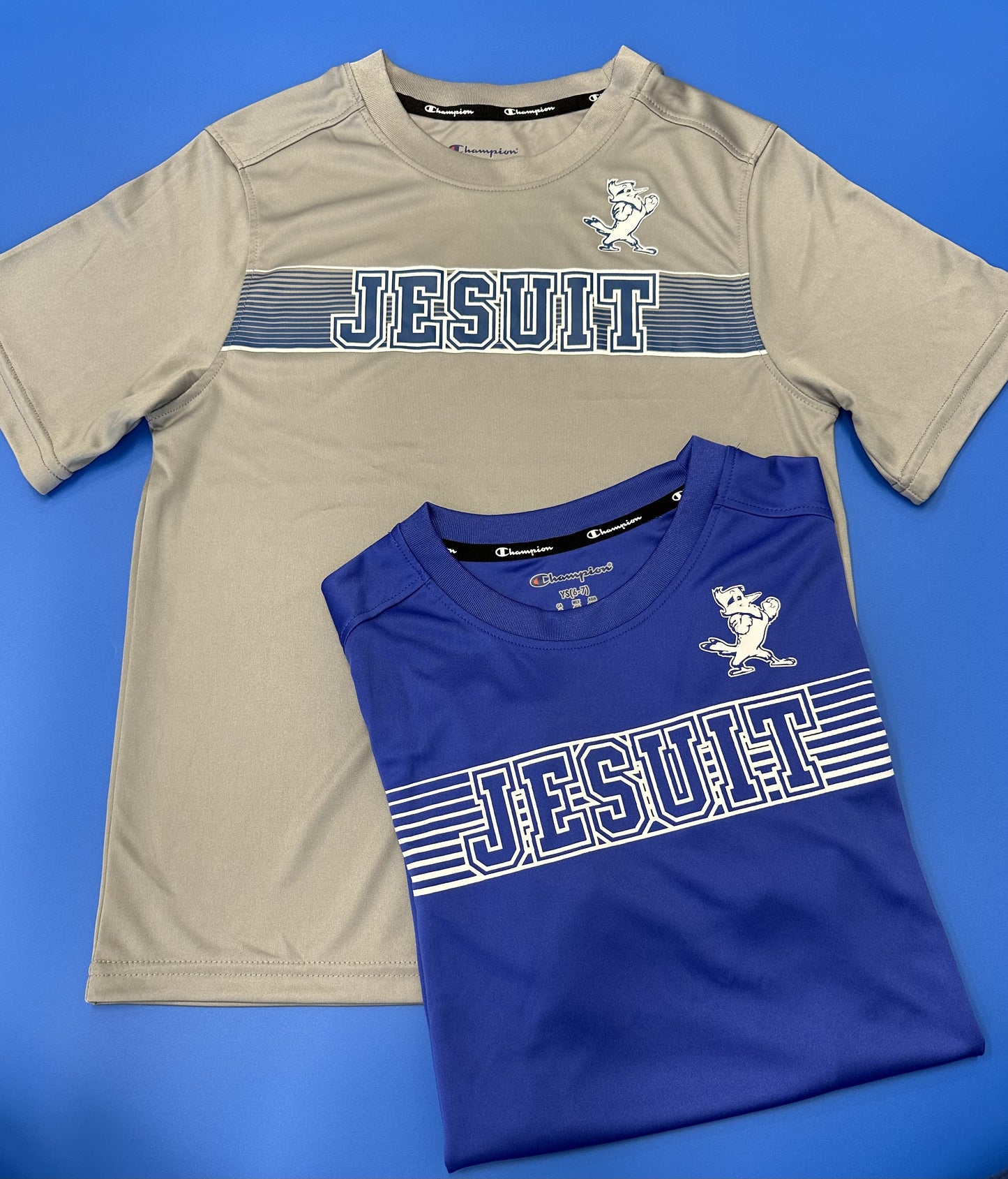 Champion. From the 2024 Stadium Collection. 100% Polyester. Self Collar. Set in sleeve construction. Screen-printed Jesuit logos.