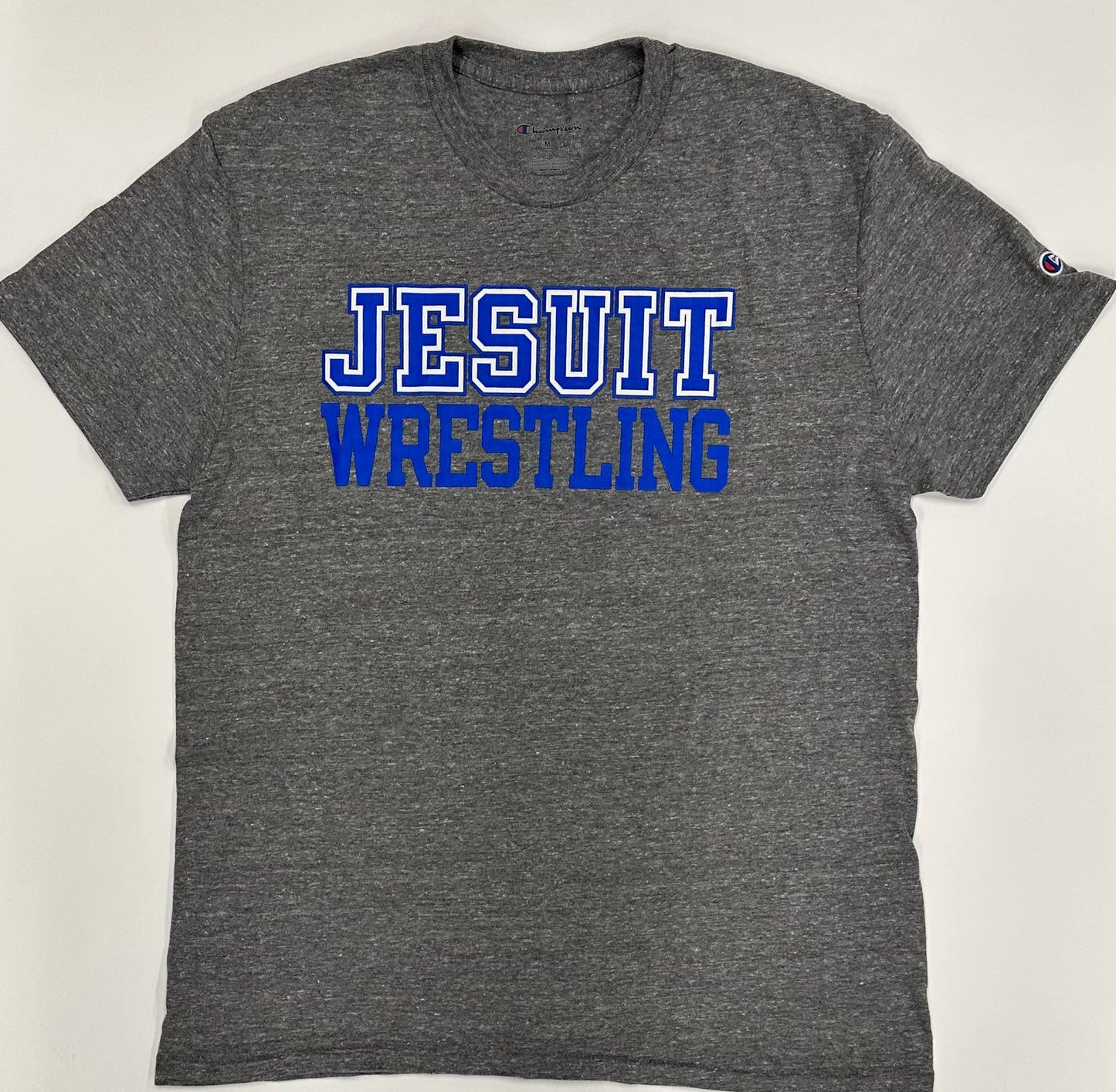 Champion.
50% Polyester/37% Cotton/13% Rayon Jersey.
1 x 1 rib at collar.
Set in short sleeve with slightly shorter, more modern fit.
Jesuit WRESTLING logo.