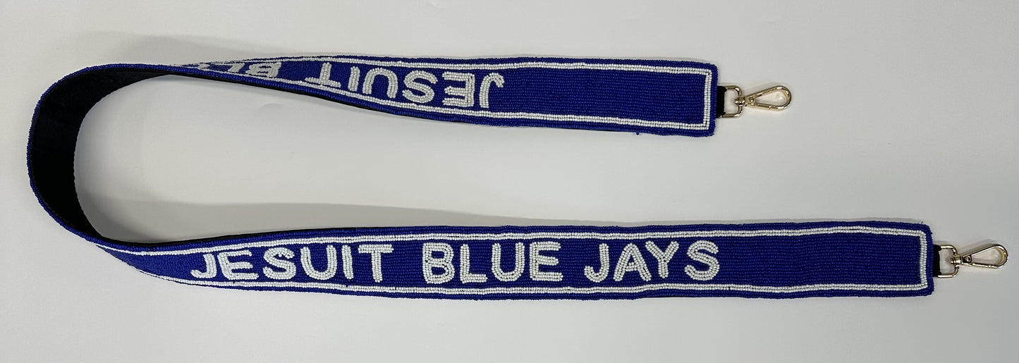 Desden. 2" beaded purse strap. Brass hardware with added padding on the backside for ultimate comfort. Sized at 45 inches long to work with most any clear bag, tote or handbag of your choice. Jesuit Blue Jays repeated twice.