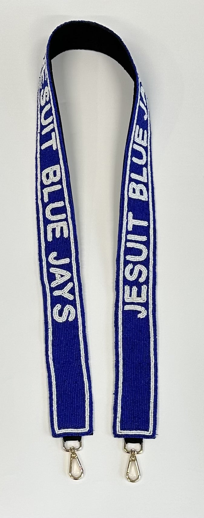 Desden. 2" beaded purse strap. Brass hardware with added padding on the backside for ultimate comfort. Sized at 45 inches long to work with most any clear bag, tote or handbag of your choice. Jesuit Blue Jays repeated twice.
