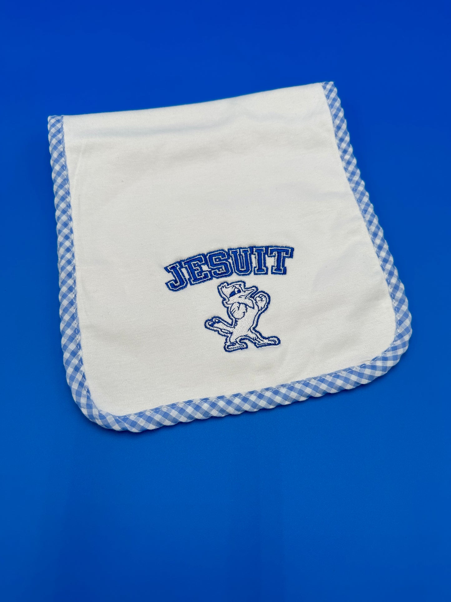 Blanks Boutique 100% combed cotton top layer w/chenille terry cloth back layer. Blue/White gingham check border. Embroidered Jesuit w/Jayson logo.