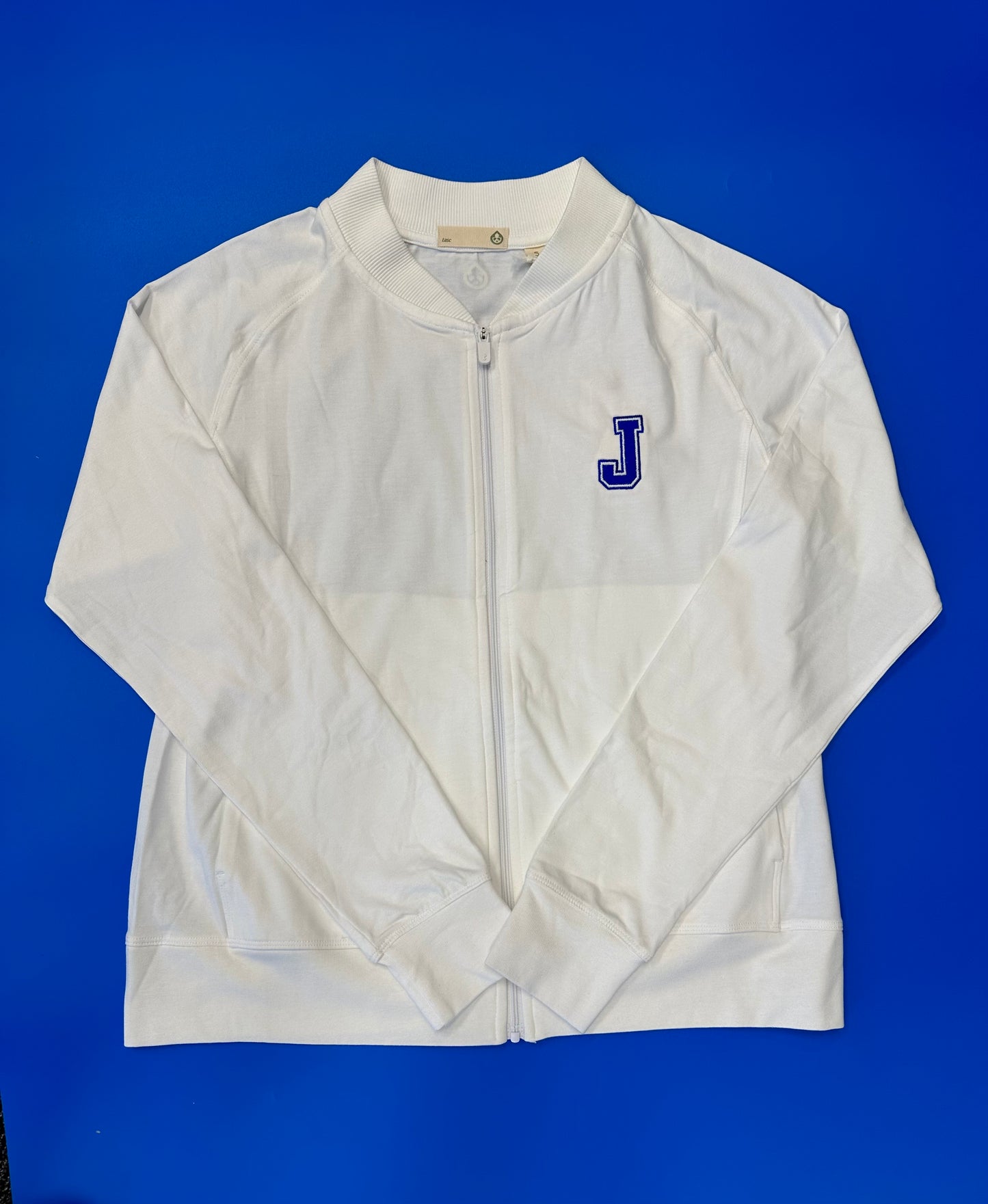 Tasc Performance. 51% Organic Cotton/41% Viscose from Bamboo/8% Lycra. Ribbed Baseball-style collar, side pockets, raglan sleeves, baby rib sleeve cuffs & bottom band, semi-fitted, 23" body length.