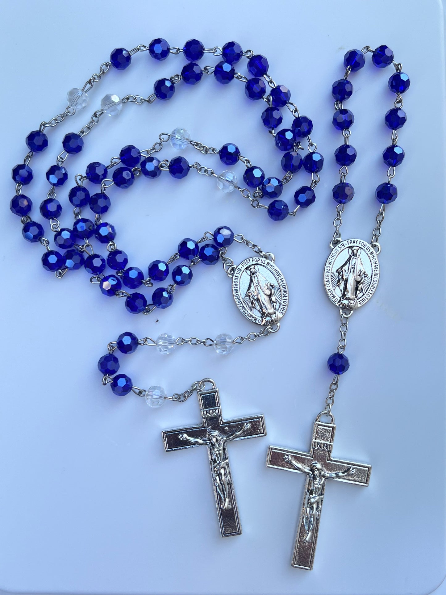 Introducing the custom designed JESUIT rosary in both full size and one decade pocket size.
The crucifix is a replica of the crucifix hanging in the Chapel of the North American Martyrs at Jesuit High School in New Orleans.& A.M.D. G. is inscribed on the backside.