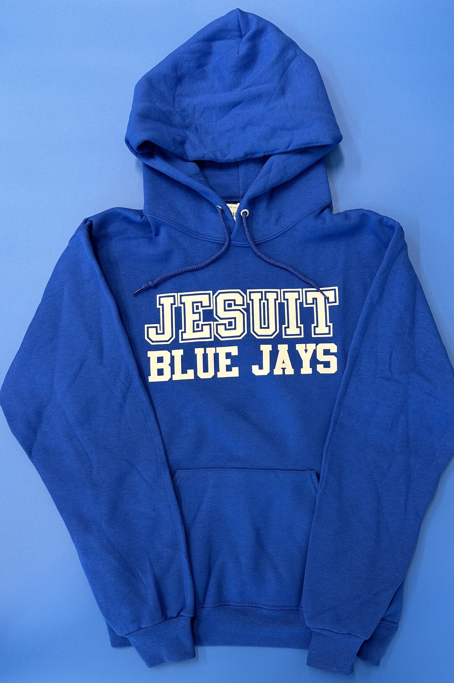 Jerzees. 50% Polyester/50% Cotton. 2 ply hood with grommets. Front pouch pocket. 1 x 1 rib cuffs and waistband. Screen printed Jesuit Blue Jays logo.