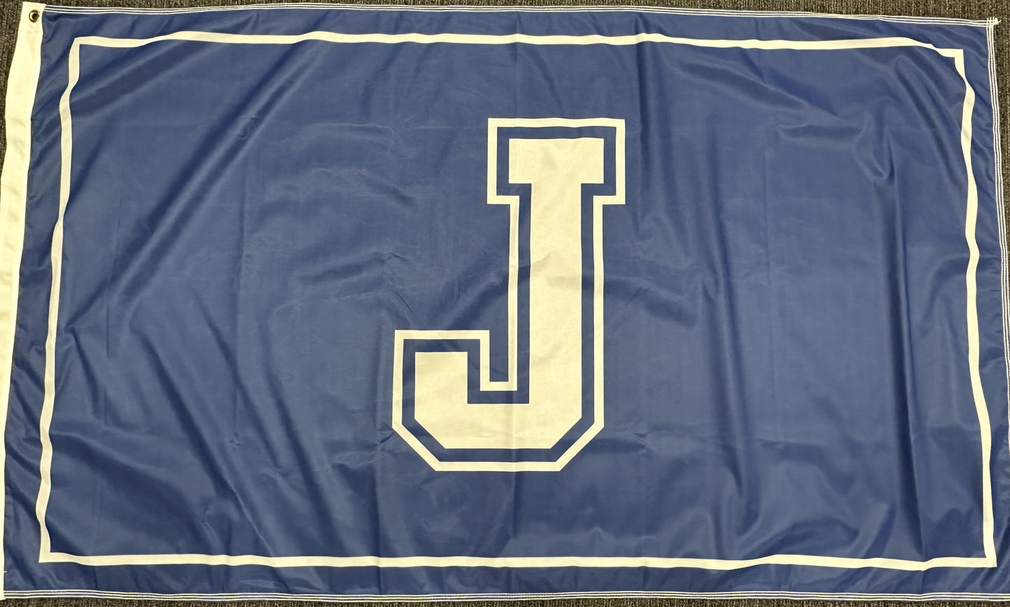 100% Polyester - Single Ply sewn w/white canvas & 2 grommets on left side.