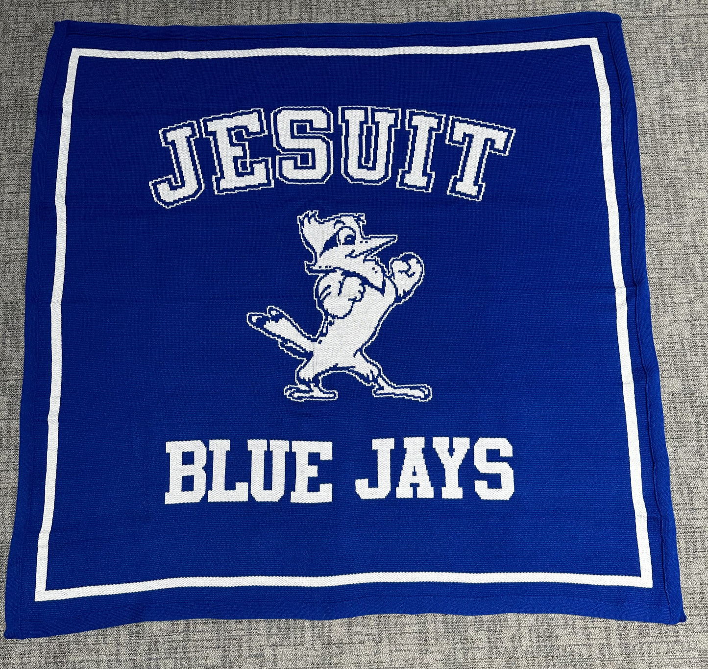 Logo Knits 100% Acrylic. Machine Washable. Measures 63 inch x 63 inch.