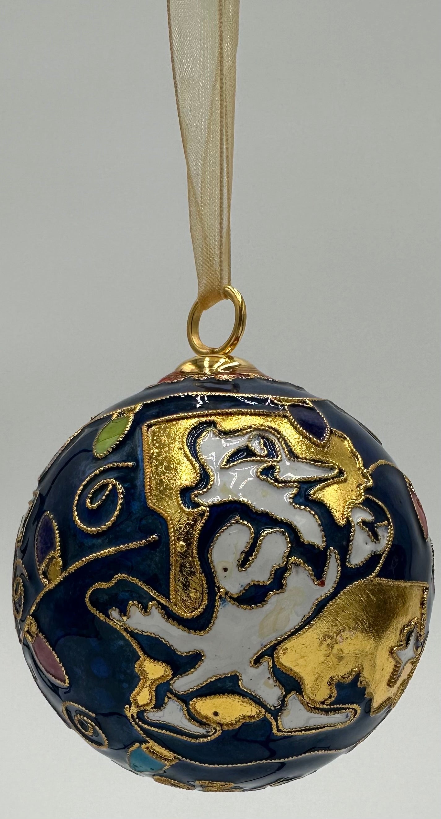 Kitty Keller Designs.
Our newest Christmas ornament to add to your collection. This year's round ornament features the JESUIT logo highlighted with festive Christmas lights and our beloved Jayson showing you exactly where we are located - NOLA!
Hand-crafted cloisonne ornaments are truly one-of-a-kind. Each gold-plated wire creating the design is formed and shaped by hand.
Comes in a silk covered gift box.