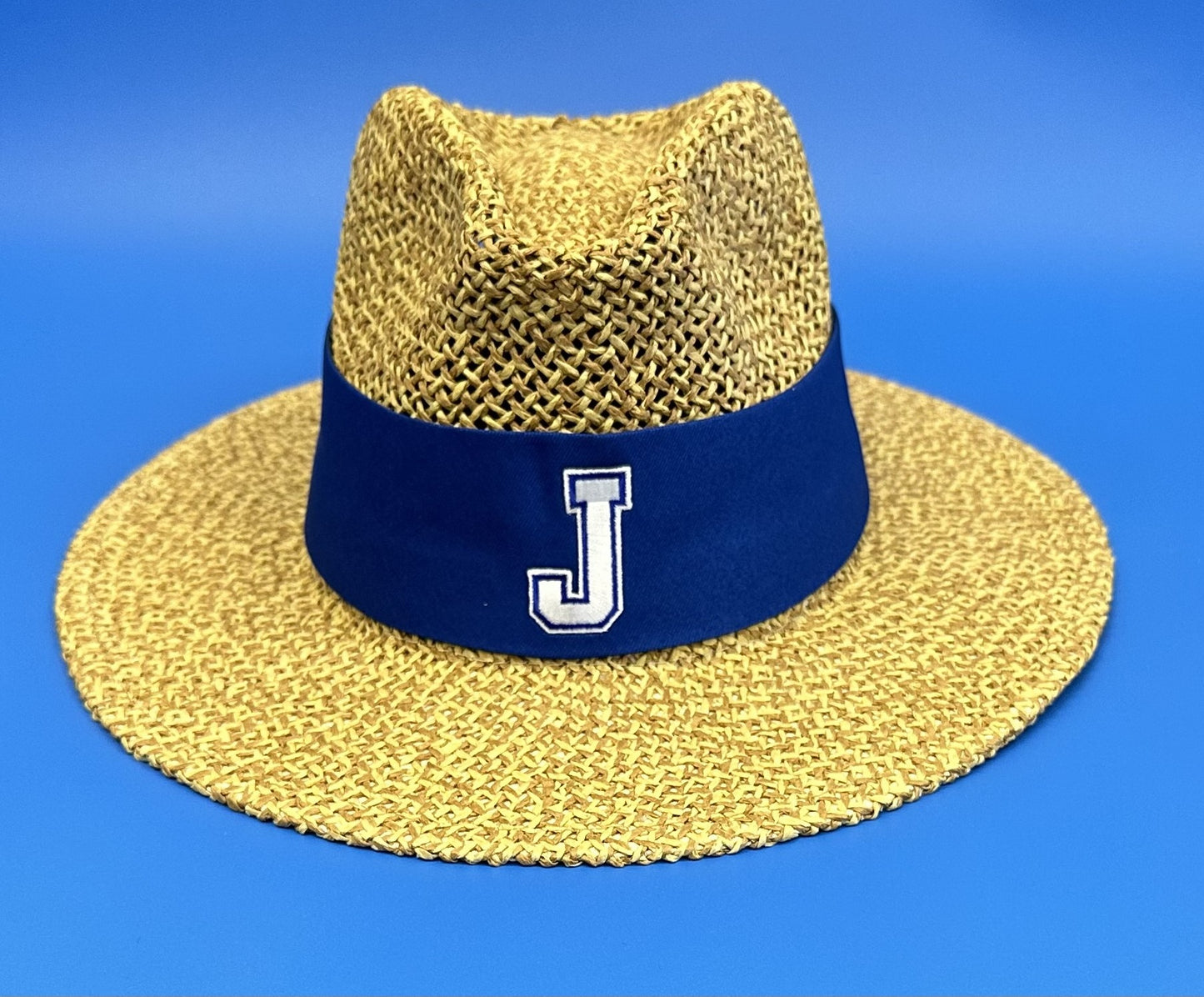 Logo Fit. UPF. Safari hat with sunblock lining and flex-fit band. Natural color straw. One size fits most. Royal blue band with J logo.