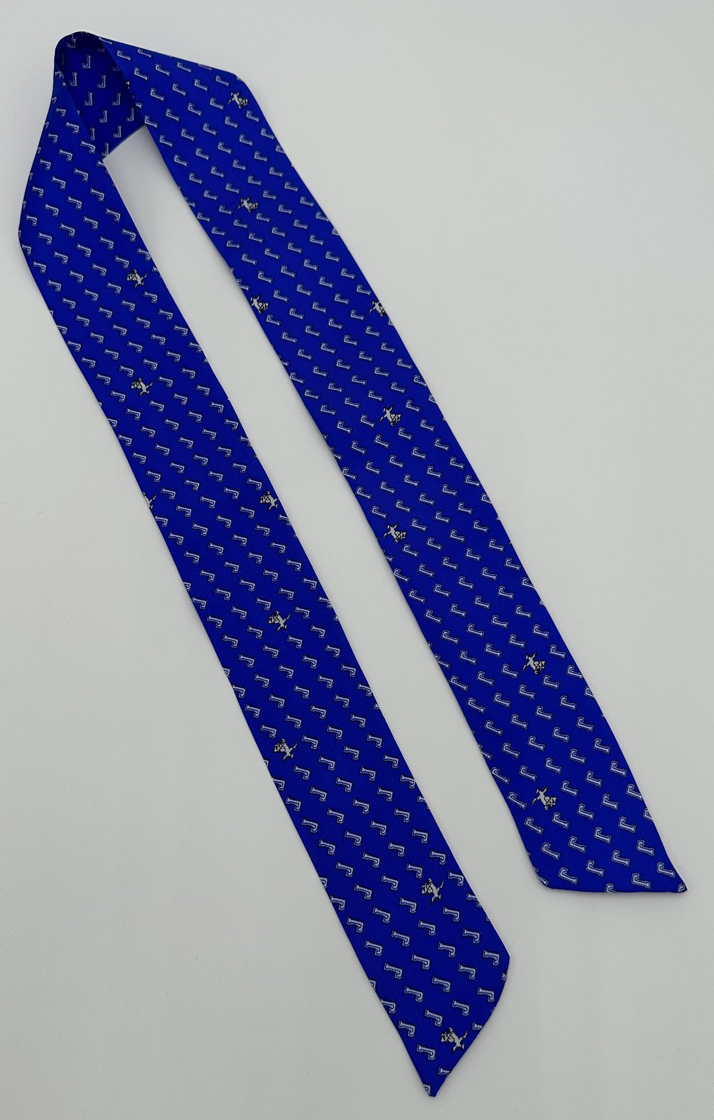 NOLA Couture. 100% Silk. Exclusive J/Jayson fabric. Double-sided narrow width fabric scarf known as a Twilly! Tie it on to your handbag strap or use in your hair or can even be used as a neck scarf! Dry Clean Only.