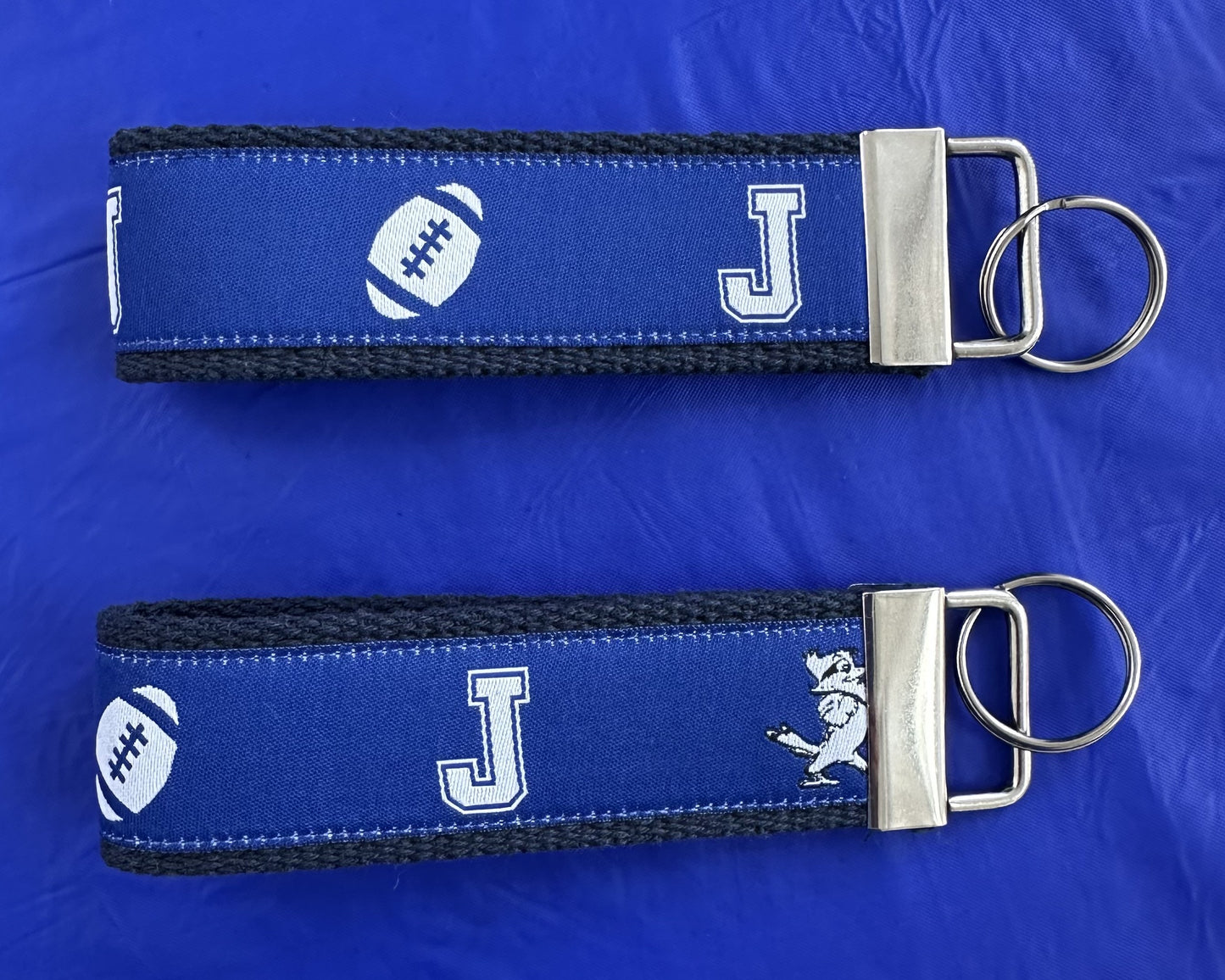 NOLA Couture.
Woven Royal Blue J w/Jayson/Football Ribbon on durable Nylon Webbing. Nickel Hardware.