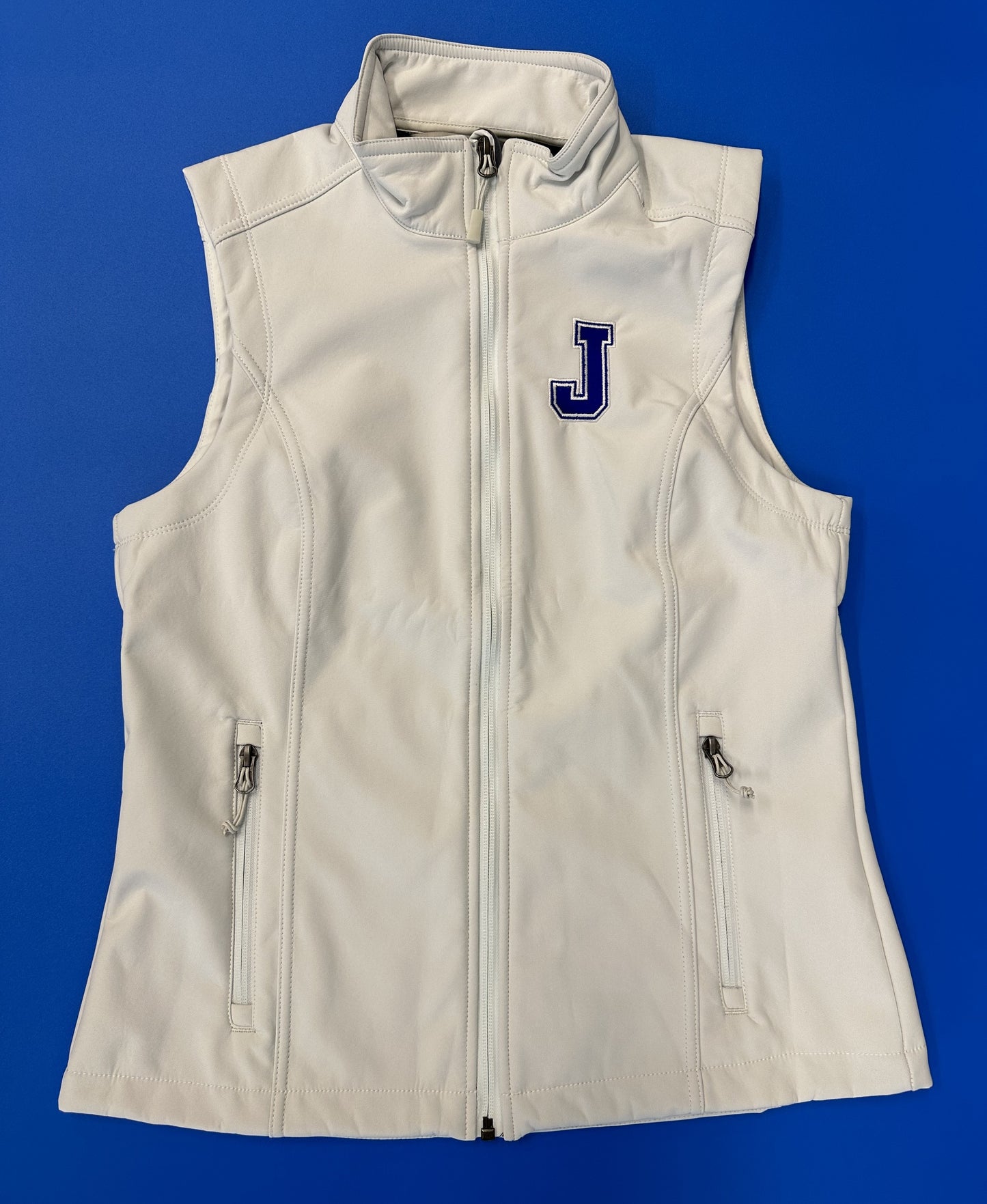 Port Authority 100% Polyester w/microfleece lining. Water-resistant. Front zippered pockets. Embroidered J logo.