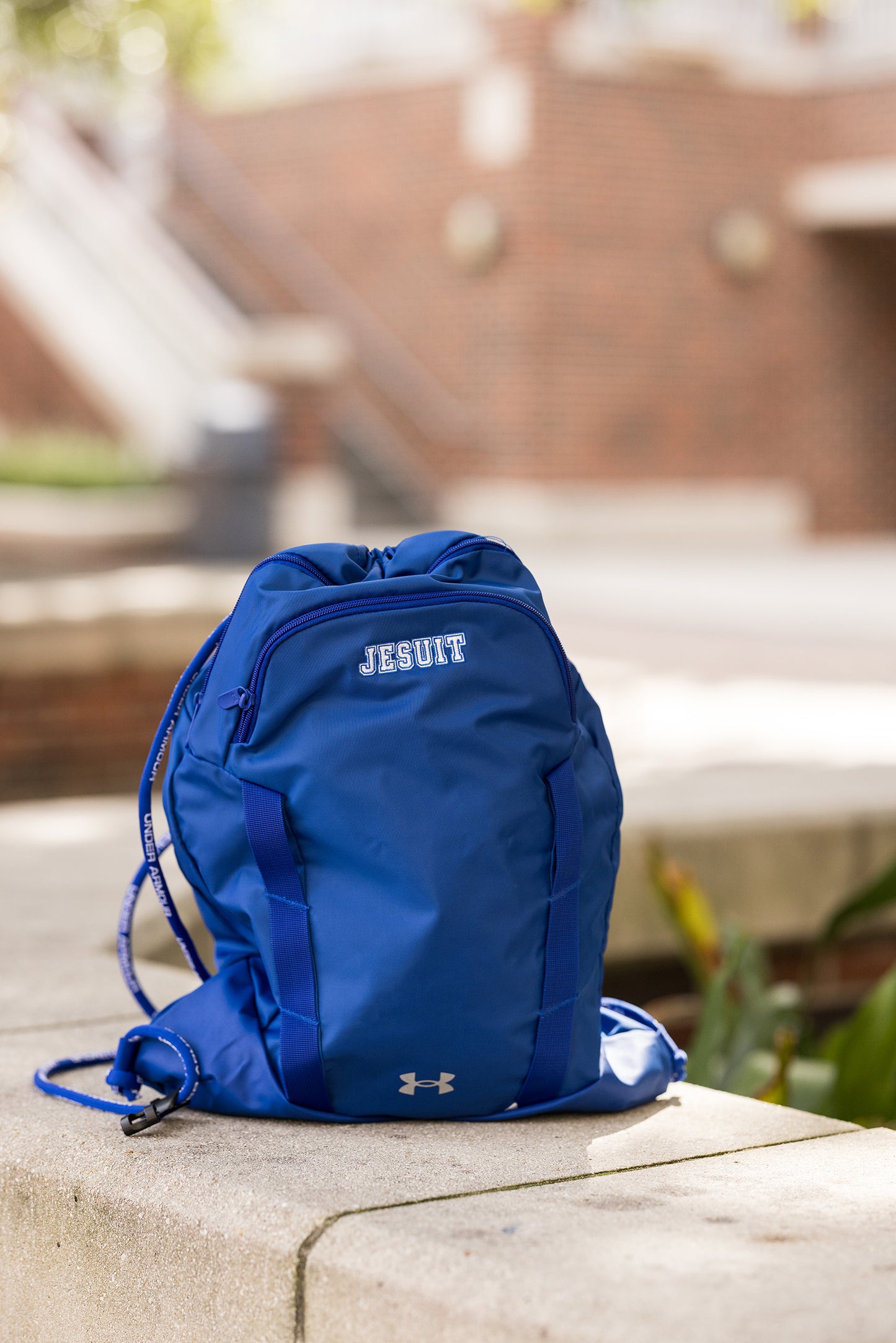 Under Armour. 100% Polyester. 2.4"W x 21.1"H x 15.4"L Water-repellent finish w/full-length front insulated zippered pocket & adjustable cording straps.