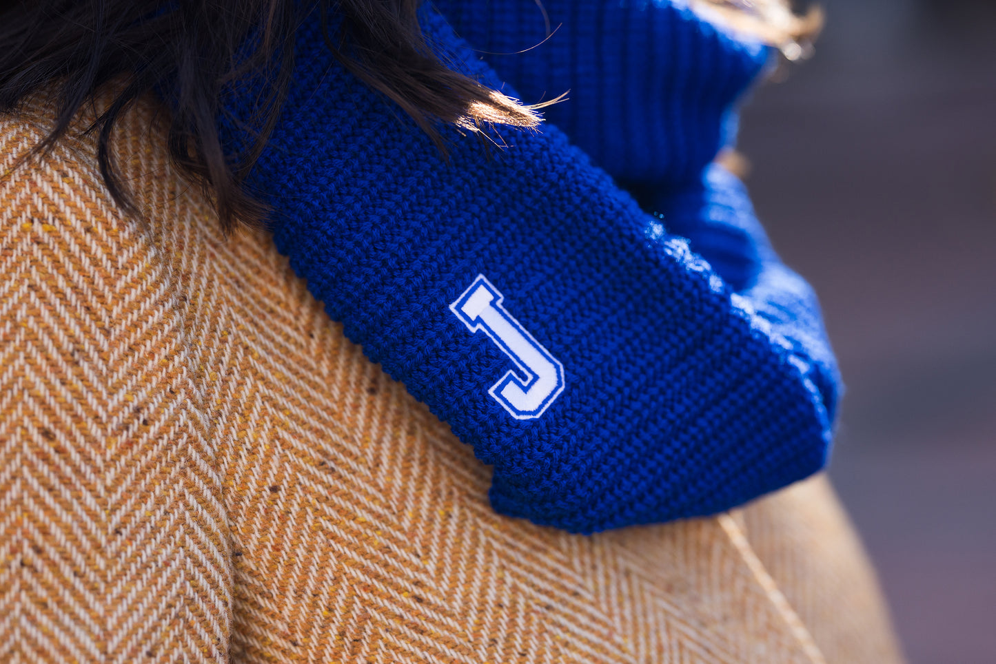 Logo Fit. 100% Acrylic. Can be worn three ways: Double loop, hood or as a shrug! Hand wash - dry flat. J logo.