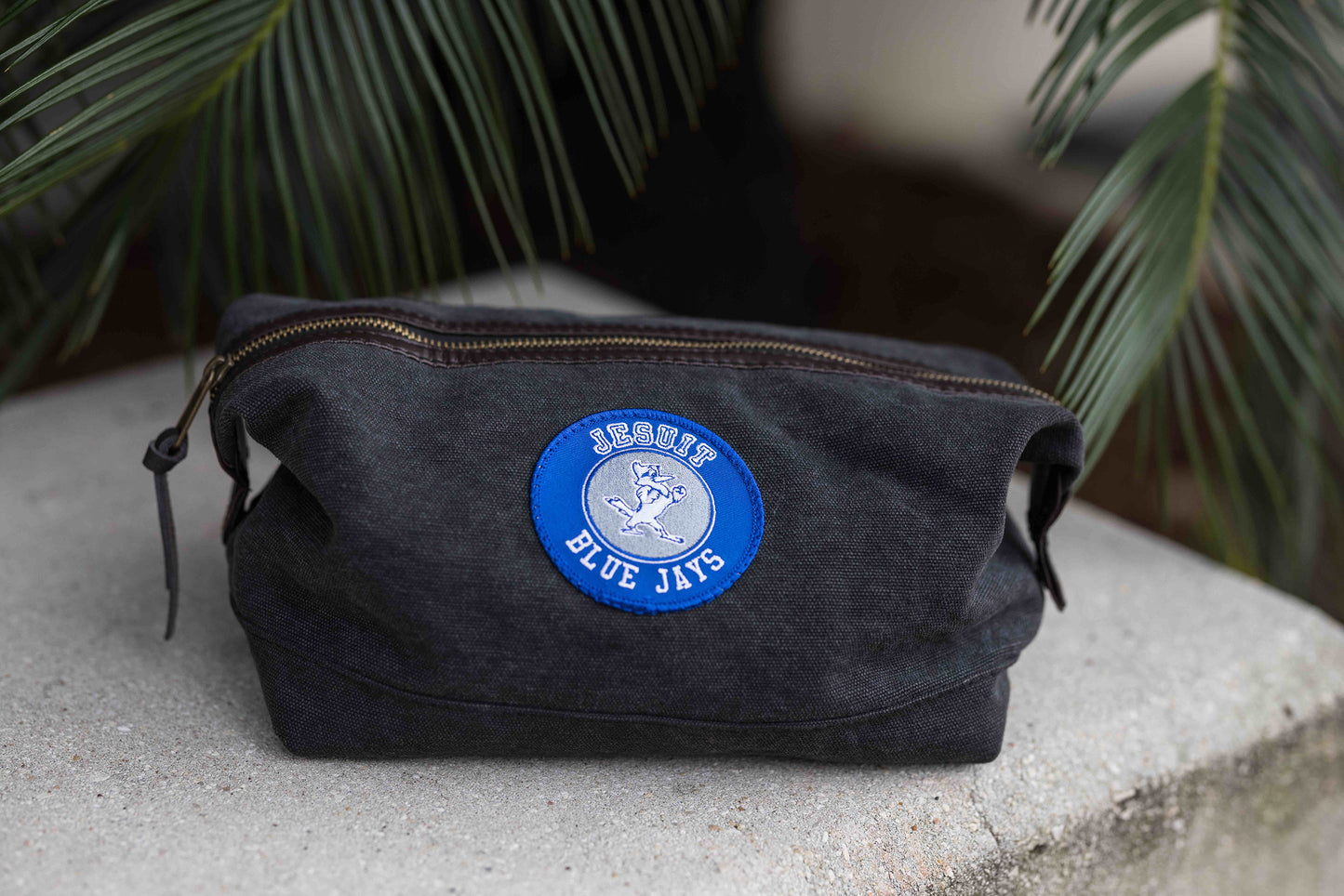 Rothco. Grey Canvas Travel Kit Bag with leather accents. Measures 9.5" x 5" x 5". Jesuit Blue Jays with Jayson patch.