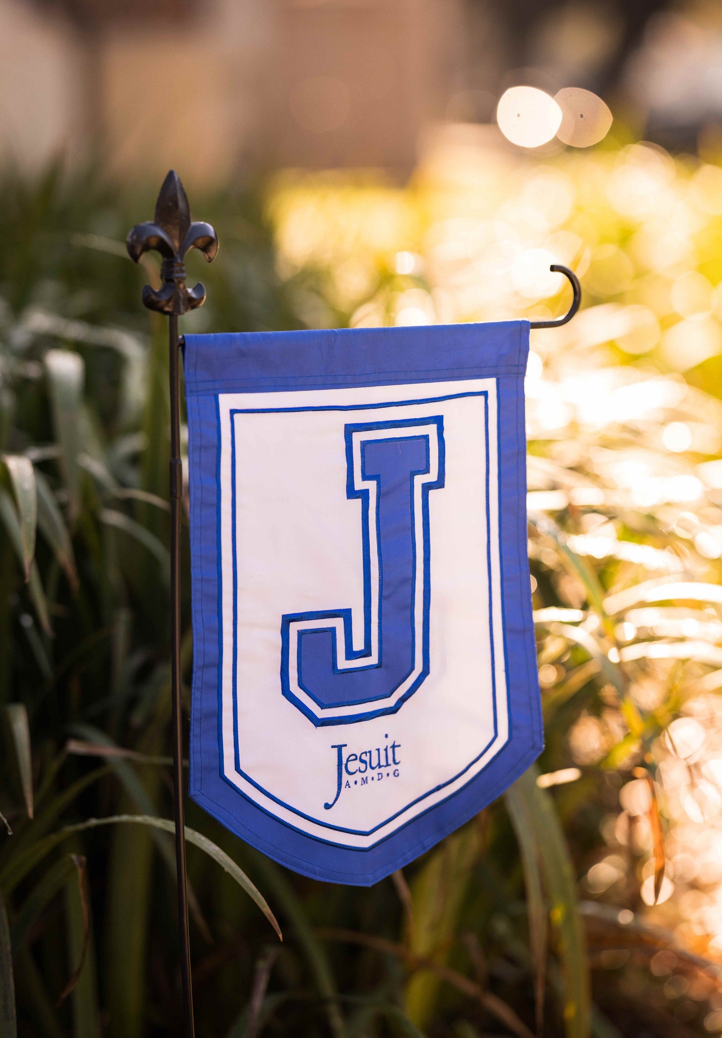 NOLA Flags. 100% Nylon. 2-sided - J and Jesuit logo. Measures 18 inch by 12 inches.
