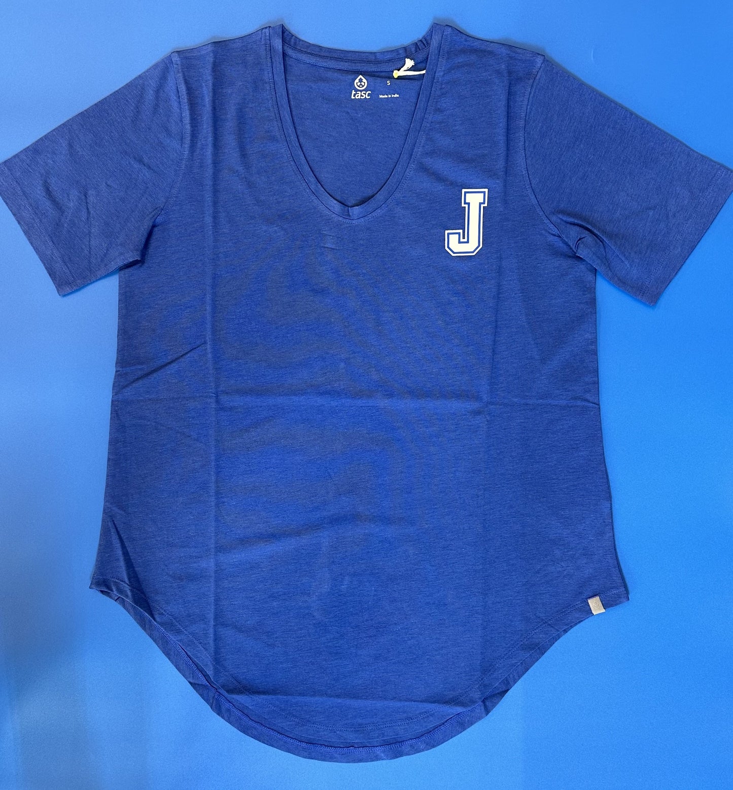 Tasc Performance. 53% Organic Cotton/43% Viscose from Bamboo/4% Lycra. U-neck, elbow length sleeves, rounded shirttail hem, tunic 29" length. Exclusive color and extended sizes made for Jesuit in this style and fabrication.