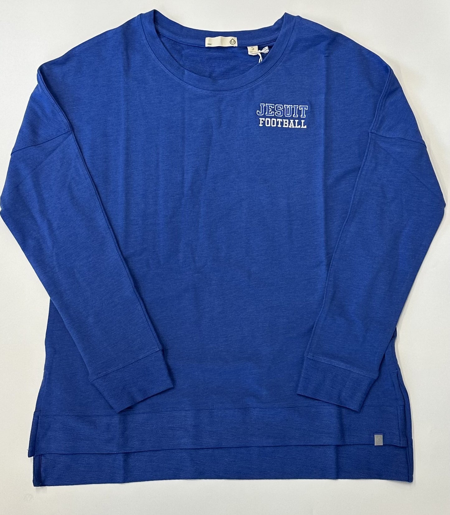 Tasc Performance. 53% Organic Cotton/43% Viscose from Bamboo/4% Lycra. Side splits, 2" drop tail, 24"/26" body length. Exclusive color for Jesuit with extended sizing. Embroidered JESUIT FOOTBALL logo.