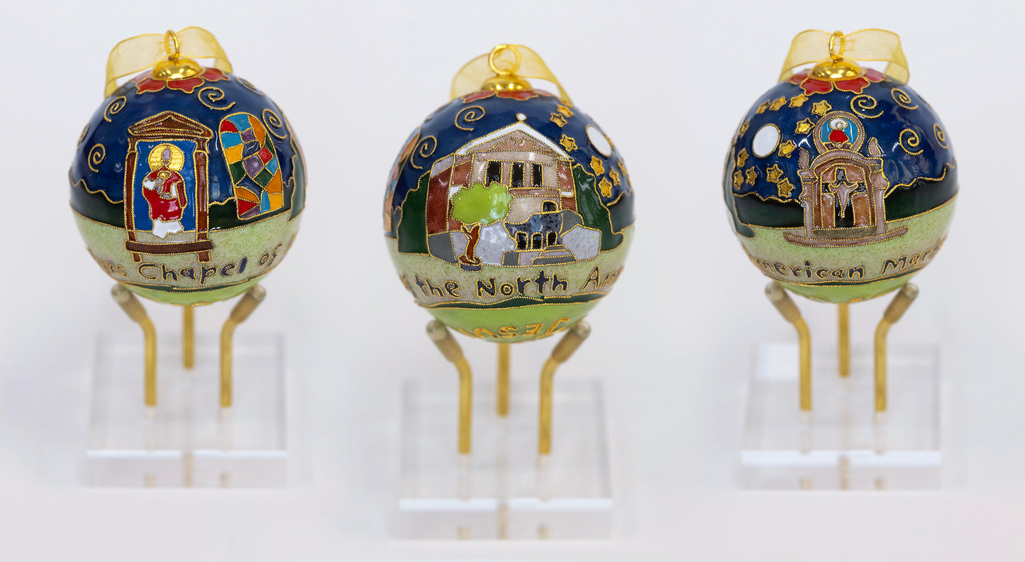 Kitty Keller Designs.
Our newest Christmas ornament to add to your collection. This year's round ornament is dedicated to The Chapel of the North American Martyrs. On their journey to become the men they were made to be, Blue Jays begin and end their education at Jesuit in the Chapel of the North American Martyrs. The chapel is the heart of student life and formation on campus.
Hand-crafted cloisonne ornaments are truly one-of-a-kind. Each gold-plated wire creating the design is formed and shaped by hand.