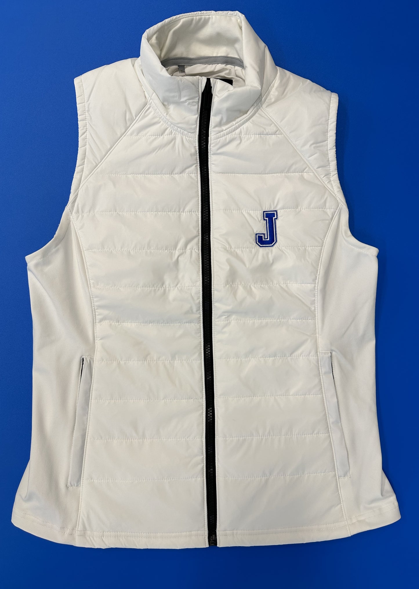 Under Armour 100% Nylon w/100% Polyester filling. Side Panels: 89% Polyester/12% Elastane. Princess lines w/in-seam pockets. Embroidered J logo.