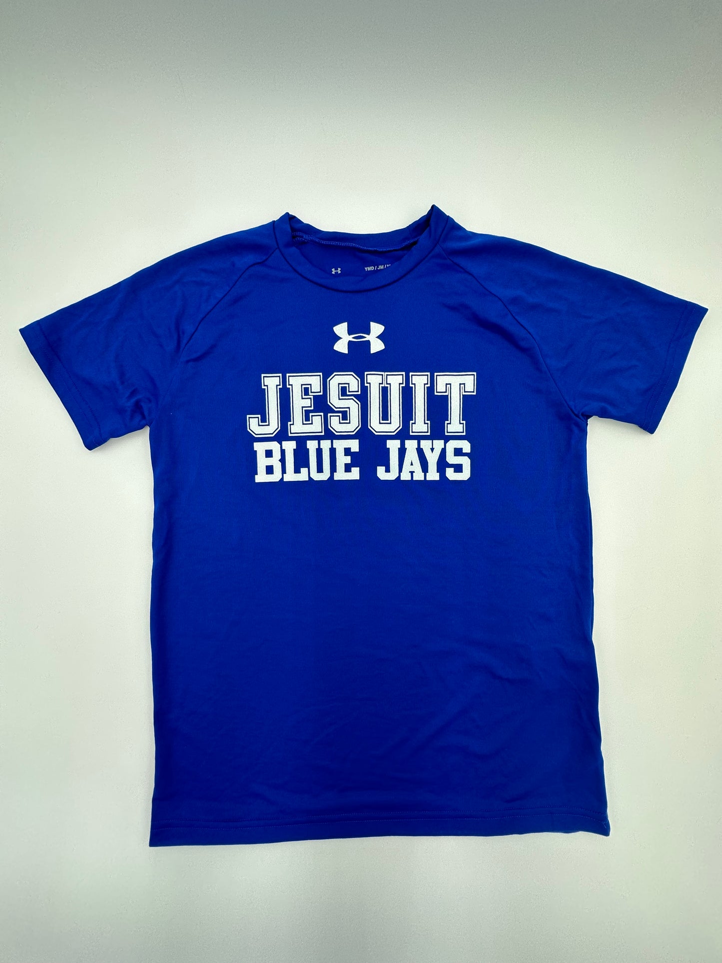 Under Armour. 100% Polyester. UA Tech fabric is quick drying, ultra-soft & has a more natural feel. Moisture transport system wicks sweat & dries really fast. Raglan sleeve construction for comfort & mobility. Curved hem with a slight drop tail.