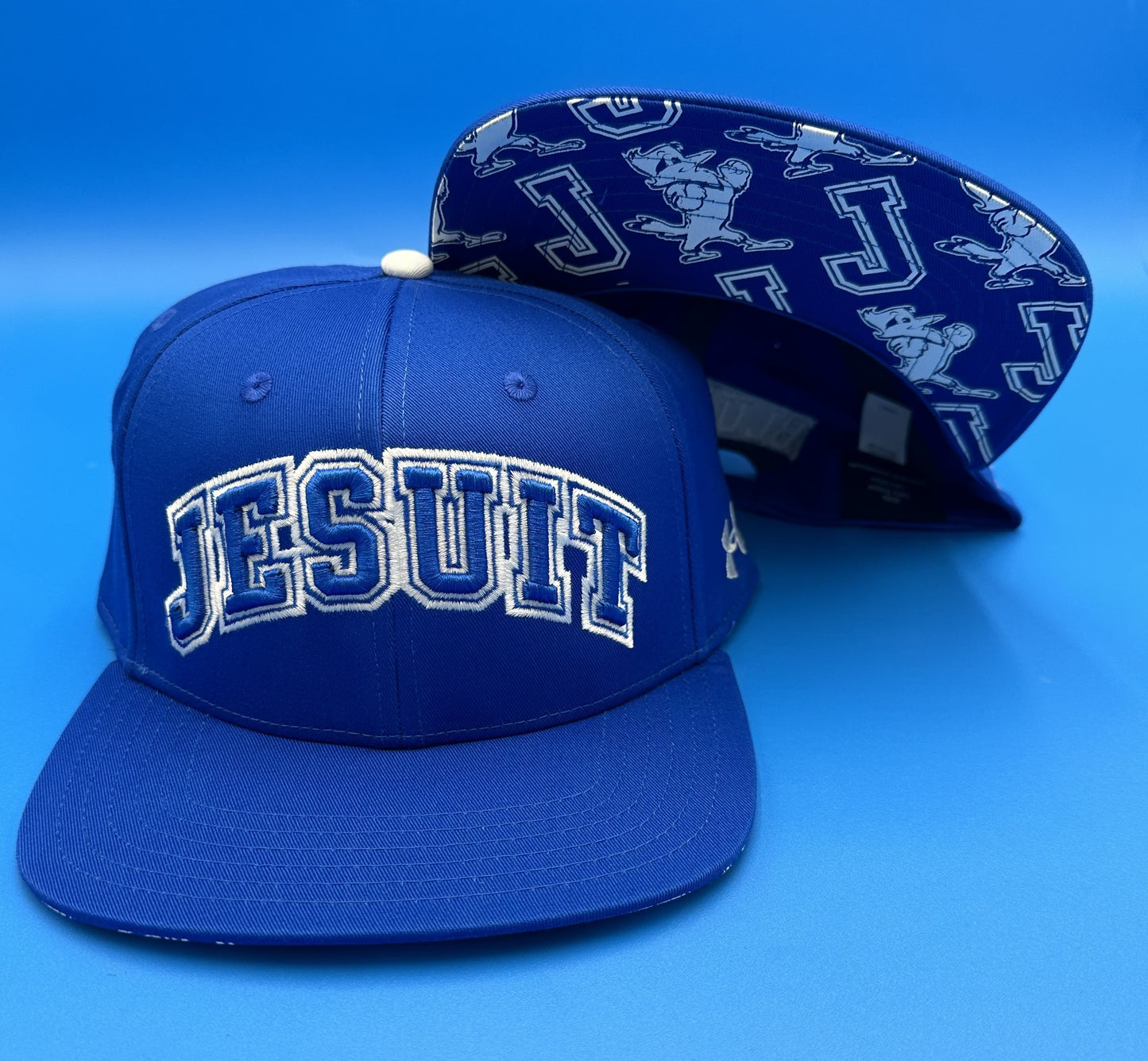 Under Armour.
One Size Fits Most.
100% Cotton Flat Bill Royal Blue hat with 3D JESUIT logo. Blue Jays on backside.
Underside of flat bill has Jayson and J logos.
Snapback closure.