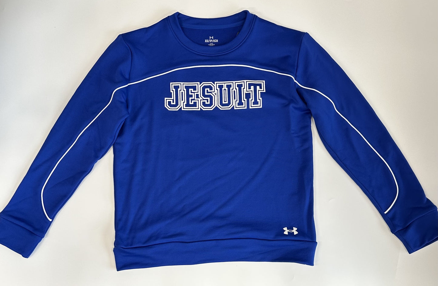 Under Armour. 100% Polyester. French terry that's stretchy, light and dries really fast. Has white piping detail. Relaxed fit and modern, shorter length.