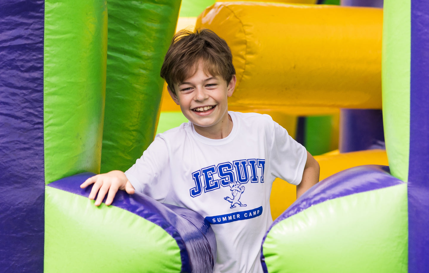 Sport-Tek.
100% polyester dry-fit.
Lightweight, roomy &amp; highly breathable. Moisture wicking. Set-in sleeves.
JESUIT summer camp logo.
White camp shirts are worn for 
grades 4-7.