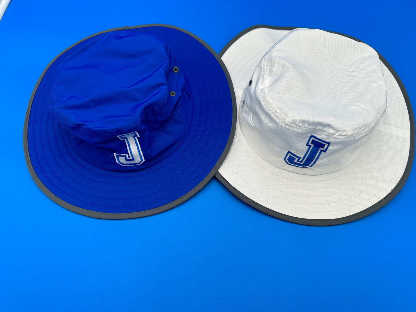 Richardson.  100% Polyester.  Lightweight Performance Fabric.  One Size Fits Most (w/adjustable elastic band).  Available with J or Jayson logo in Royal Blue or White!