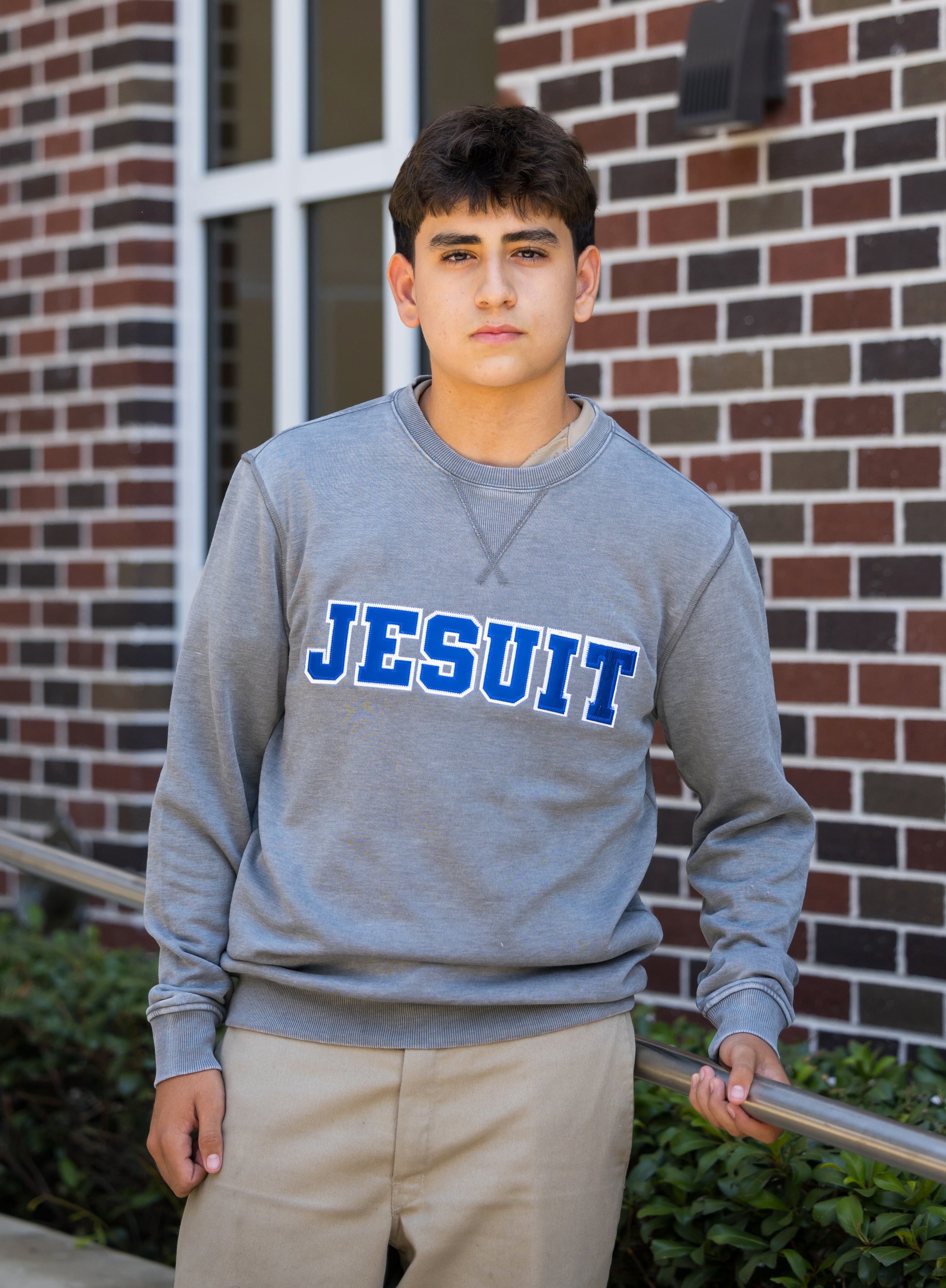 Camp David.

57% Cotton/43% Polyester.

8 oz. fleece. Generous fit.&nbsp; Both the fabric and the 2x2 rib at the neckline, cuff and waistband feature a 'vintage' look achieved using a unique wash treatment.

JESUIT logo with 'NOLA' inside the T.