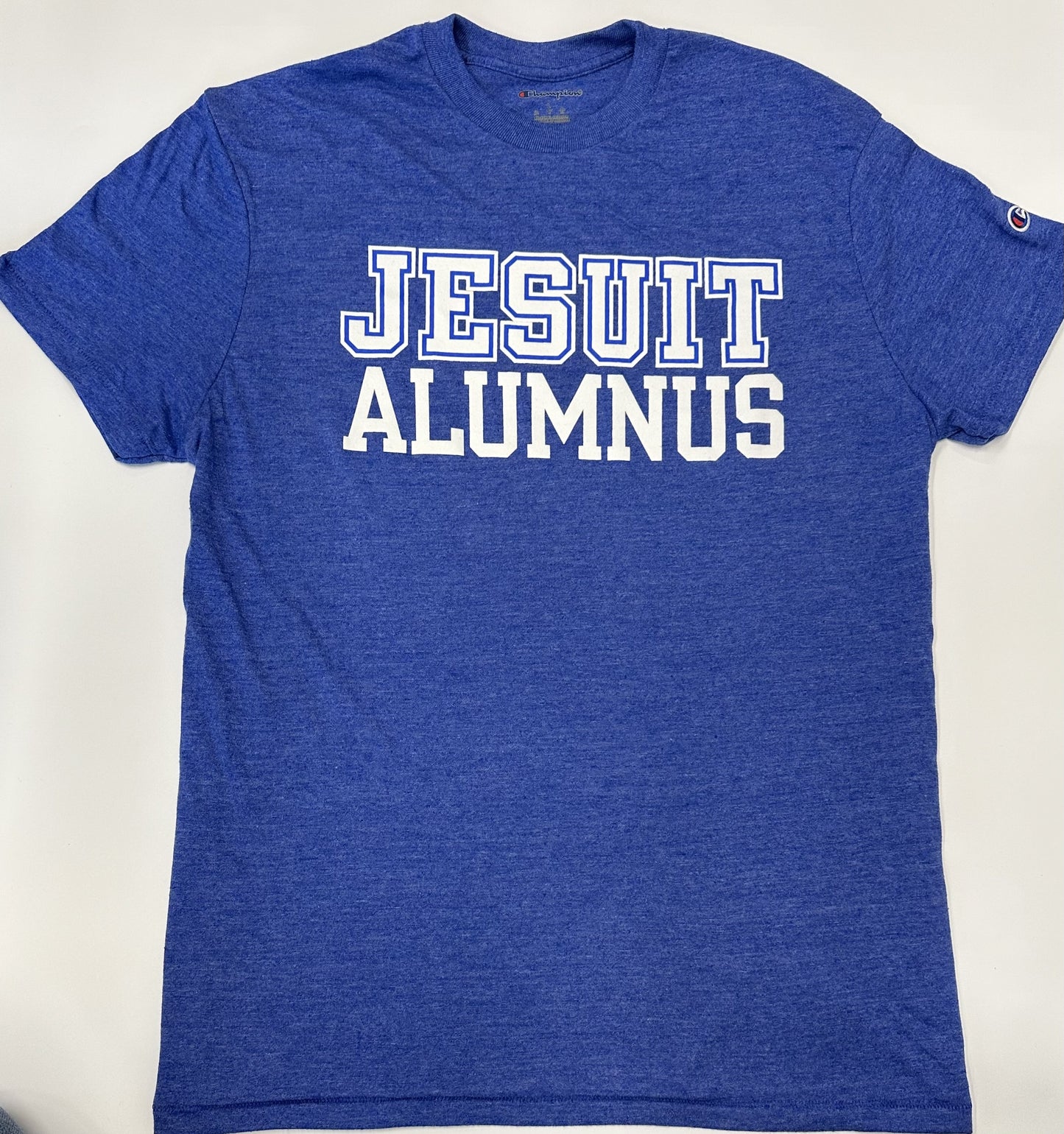 Champion. 50% Polyester/37% Cotton/13% Rayon Jersey. 1 x 1 rib at collar. Set in short sleeve with slightly shorter, more modern fit. Jesuit Alumnus logo.