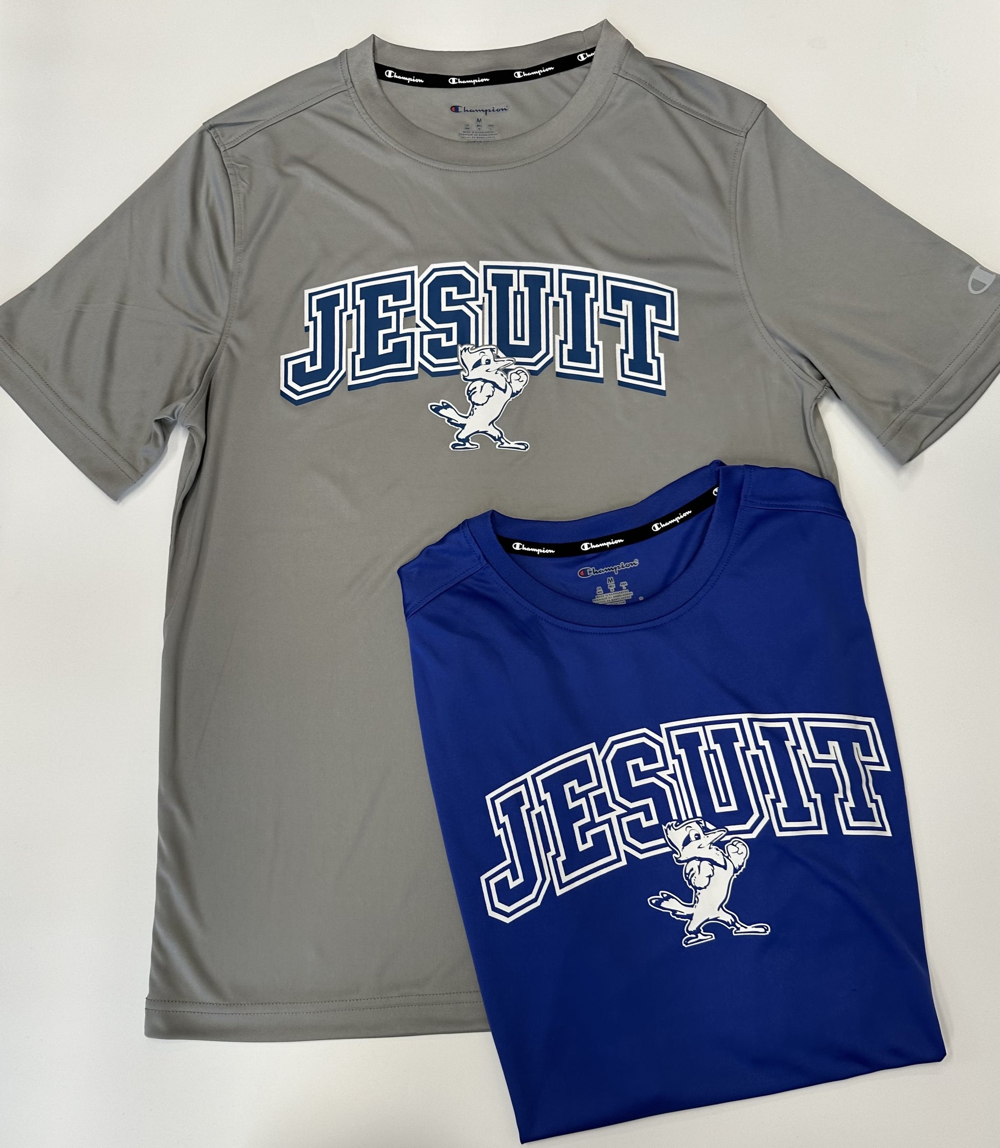 Champion. From the 2024 Stadium Collection. 100% Polyester. Self Collar.  Set in sleeve construction. Screen-printed Jesuit logos.