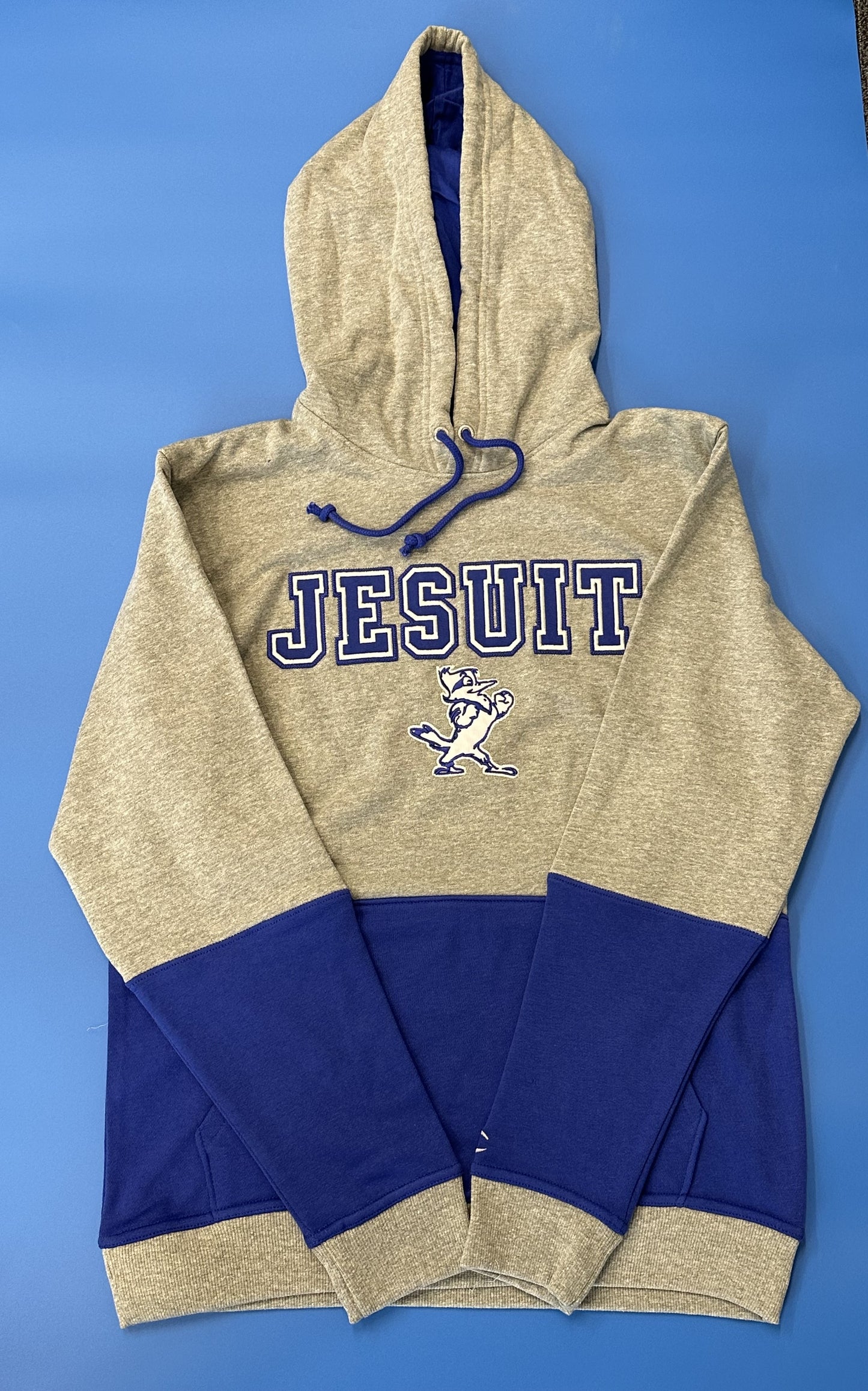 Champion.  70% Cotton/30% Polyester.  Tackle Twill applique - Jesuit with Jayson