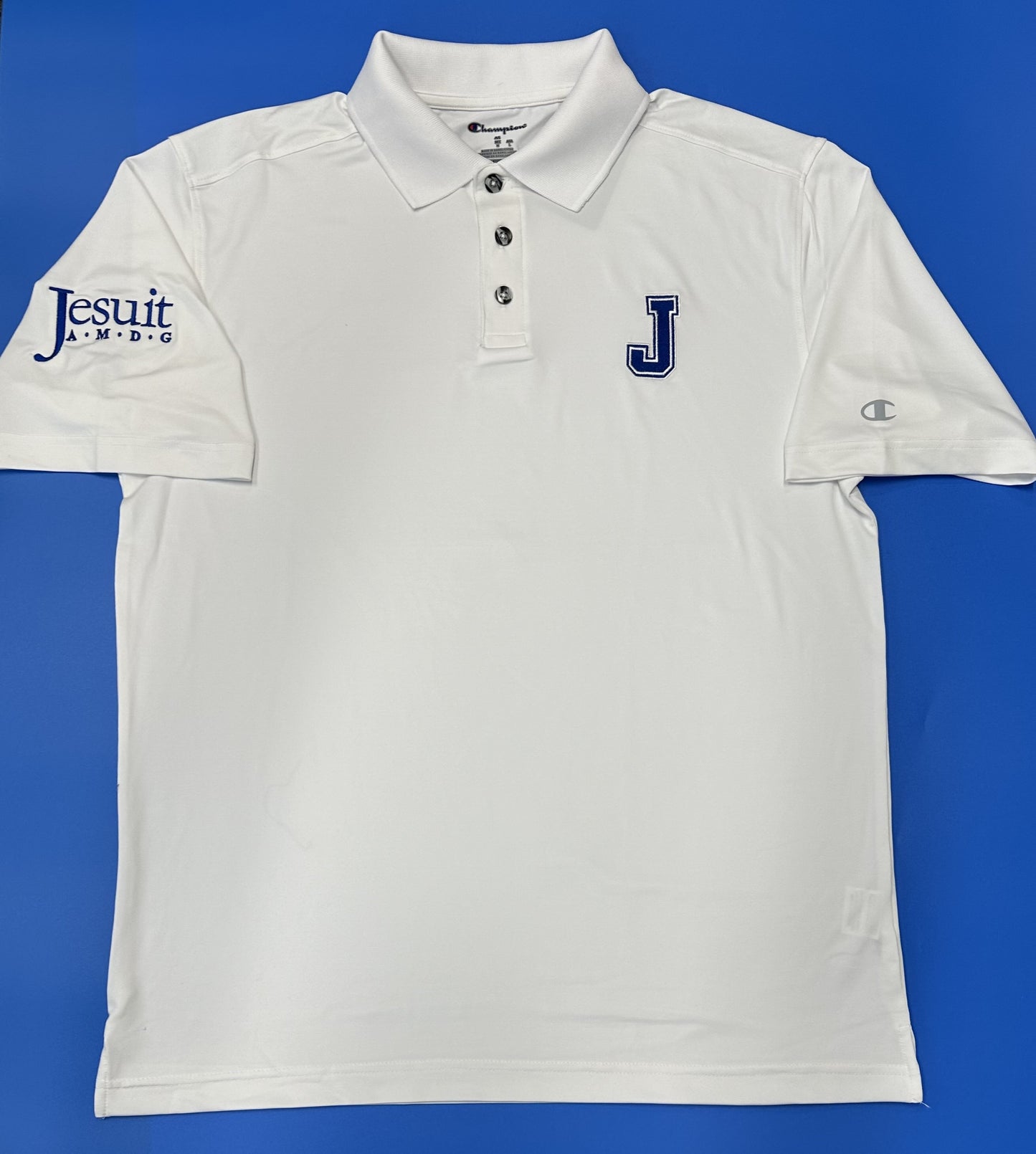 Champion. 90% Polyester/10% Elastane. From the 2024 Stadium Collection. Rib knit collar with 3-button placket. Standard finish sleeve and hem. Straight body fit with side vents for added movement. Embroidered J logo on left chest and Jesuit A. M. D. G. logo on right sleeve.