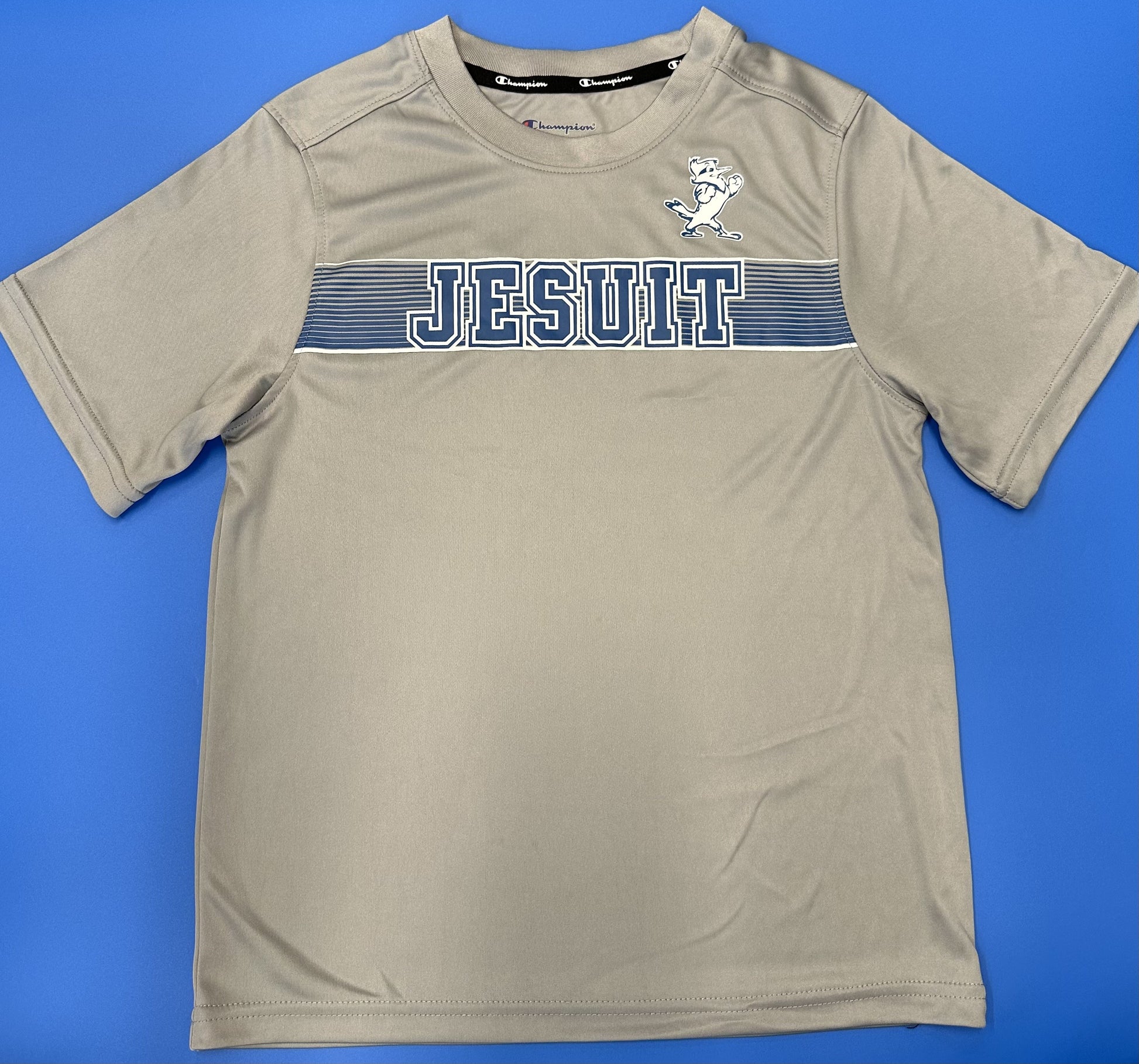 Champion. From the 2024 Stadium Collection. 100% Polyester. Self Collar. Set in sleeve construction. Screen-printed Jesuit logos.