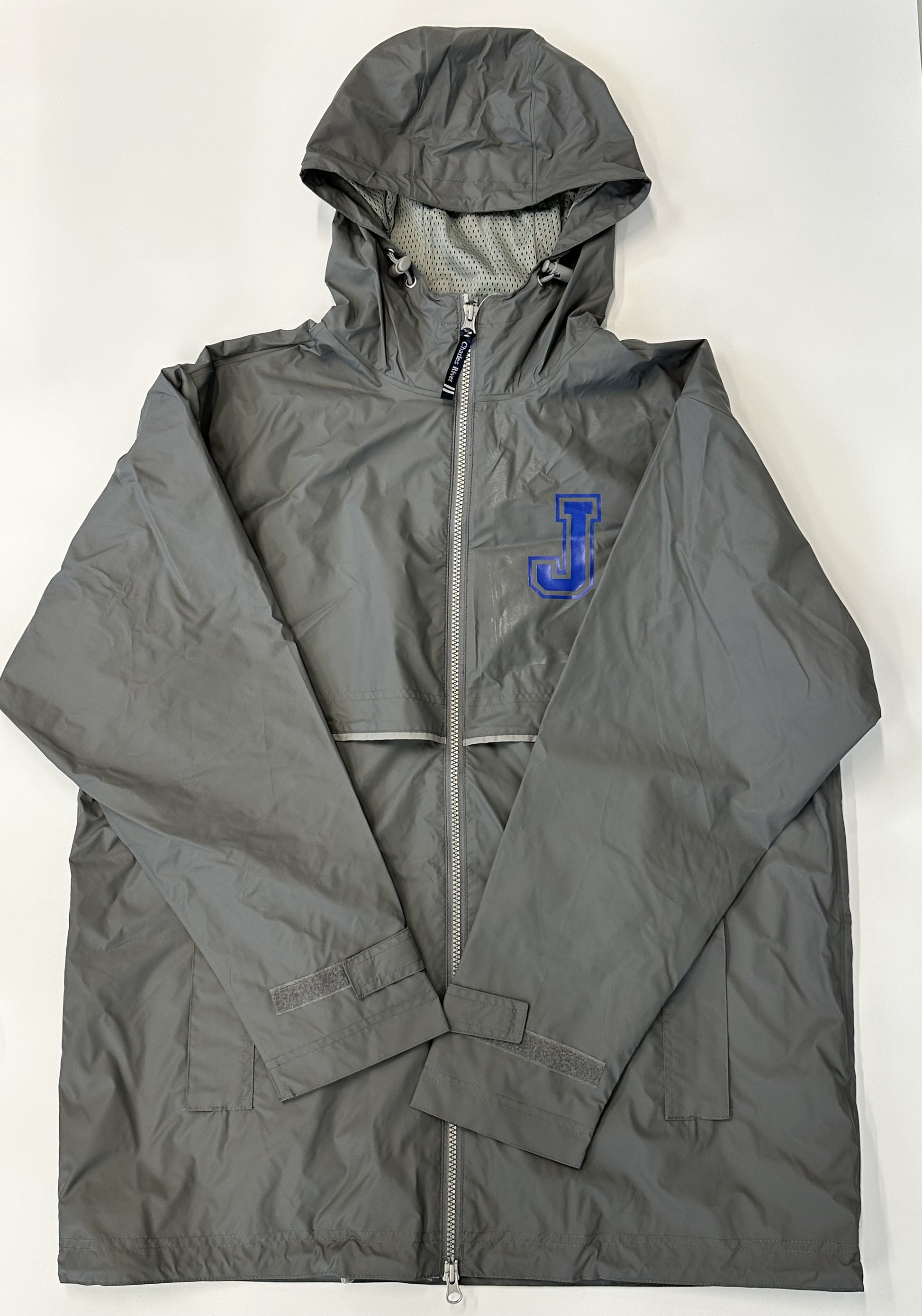 Charles River.  Shell:  100% Polyurethane  Backing & Body lining:  100% Polyester  Wind & Waterproof w/heat sealed seams for weather protection.  2 way zipper for easy movement.  Reflective trim across back for visibility.  Runs big so you may want to size down!