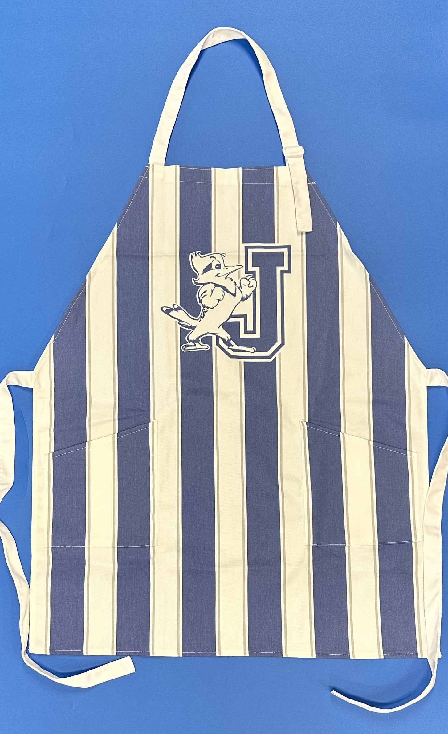 Desden.  'Vintage' tailgate apron in classic stripes. Generously sized. Made from thick twill fabric and features adjustable straps and dual pockets for cooking tools.  J/Jayson logo.