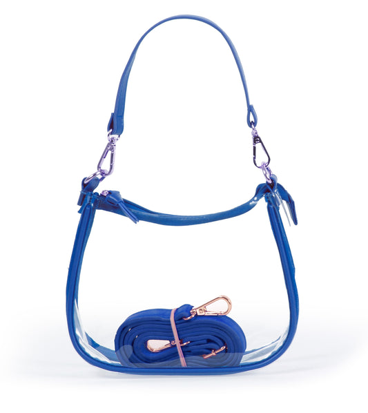 Desden.

9.25" x 6" x 2.5".

The Clara Clear Purse features two sets of straps, a secure zipper closure, and high-quality brass-finished hardware. Stadium-approved.