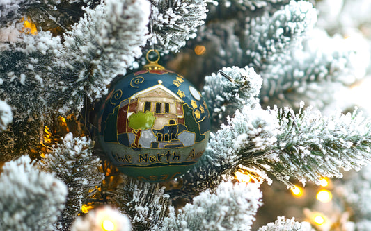 Kitty Keller Designs.
Our newest Christmas ornament to add to your collection. This year's round ornament features The Chapel of the North American Martyrs.  On their journey to become the men they were made to be, Blue Jays begin and end their education at Jesuit in the Chapel of the North American Martyrs. The chapel is the heart of student life and formation on campus.
Hand-crafted cloisonne ornaments are truly one-of-a-kind. Each gold-plated wire creating the design is formed and shaped by hand.
