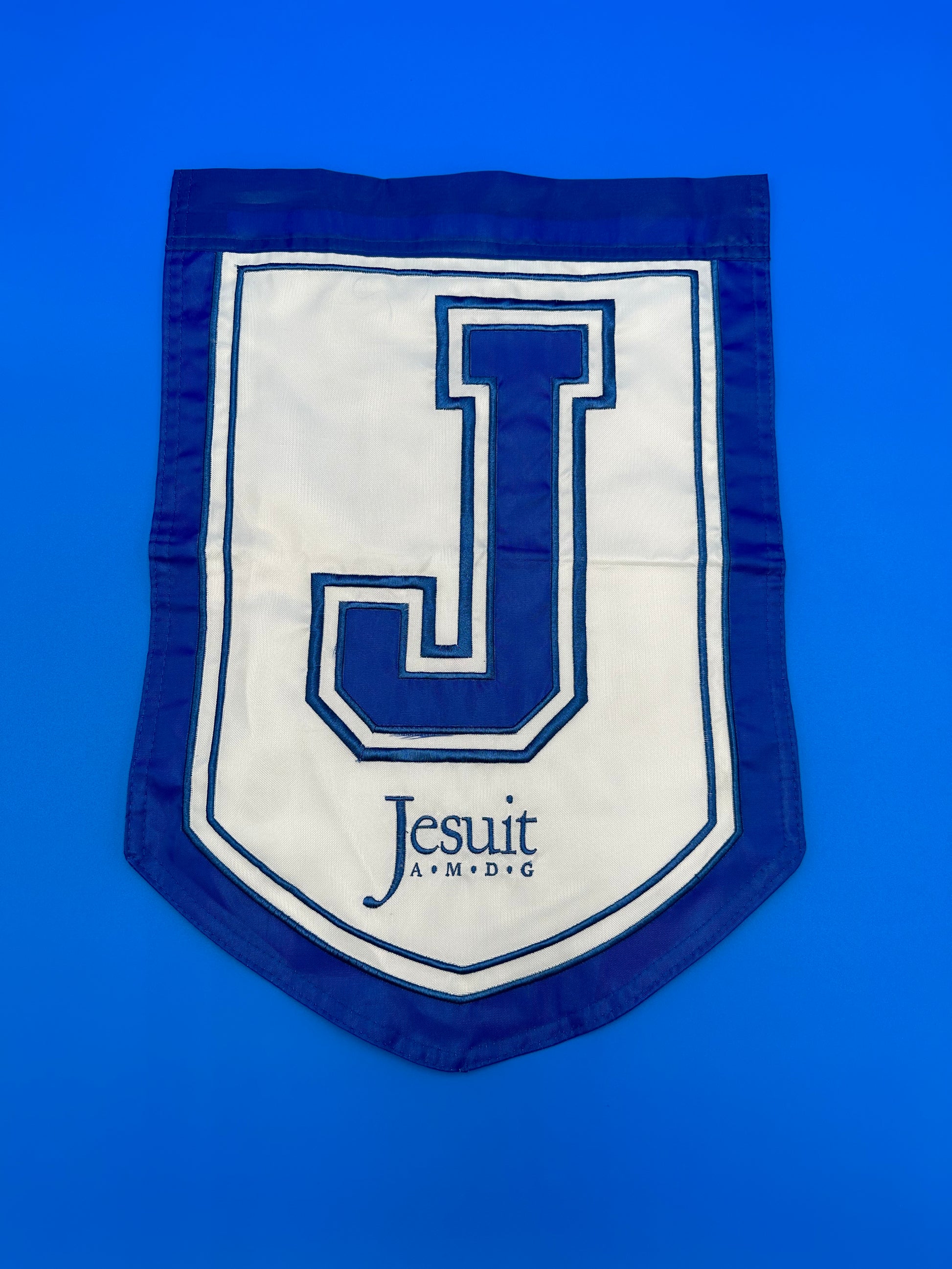 NOLA Flags.  100% Nylon.   2-sided - J and Jesuit logo. Measures 18 inch by 12 inches.