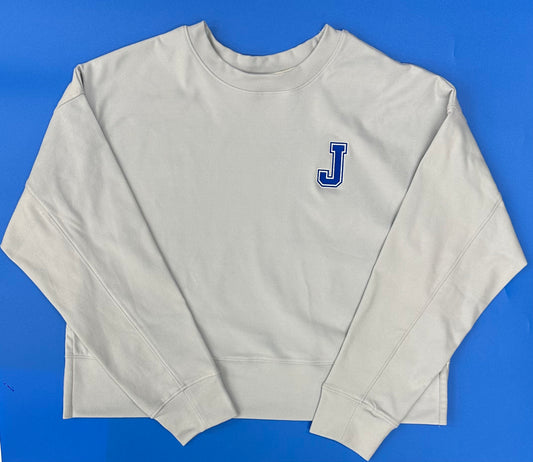 Champion.

88% Polyester, 12% Spandex Sueded fleece.

Set in self-collar, dropped shoulder, seaming down front/back of sleeve. Self-cuff and waistband with side vents. Fit is oversized and cropped.

Embroidered J logo.