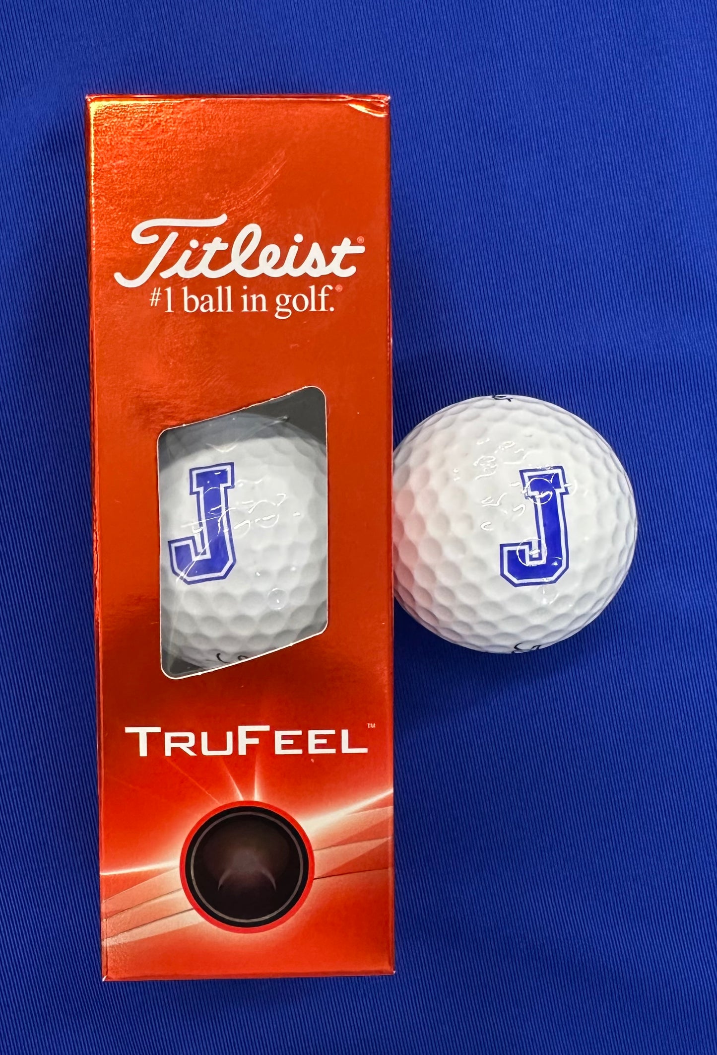 Titleist.

The Titleist TruFeel golf ball is designed for long distance and reliable greenside spin. With a soft 3.0 TruFlex cover, TruFeel delivers short game control with extraordinary durability. Built with a TruTouch core, Trufeel delivers long distance and ultra-soft feel.

Set of 3 balls with J logo.