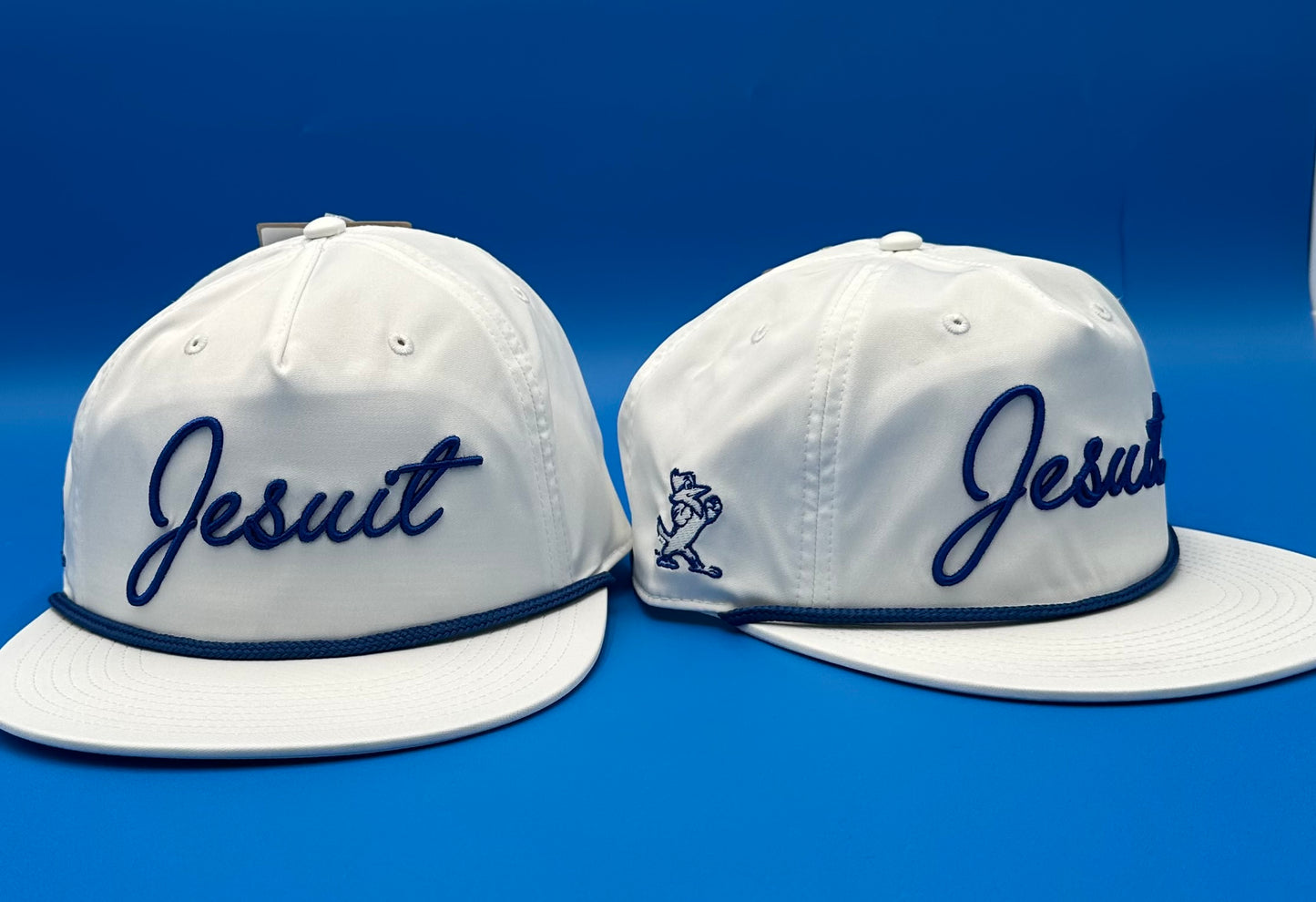 The Game.

97% Polyester/3% Spandex.&nbsp; One size fits most.

Flat bill baseball hat with performance 5-Panel gamechanger. Snapback with rope detail.

Jesuit cursive logo with Jayson logo on side.